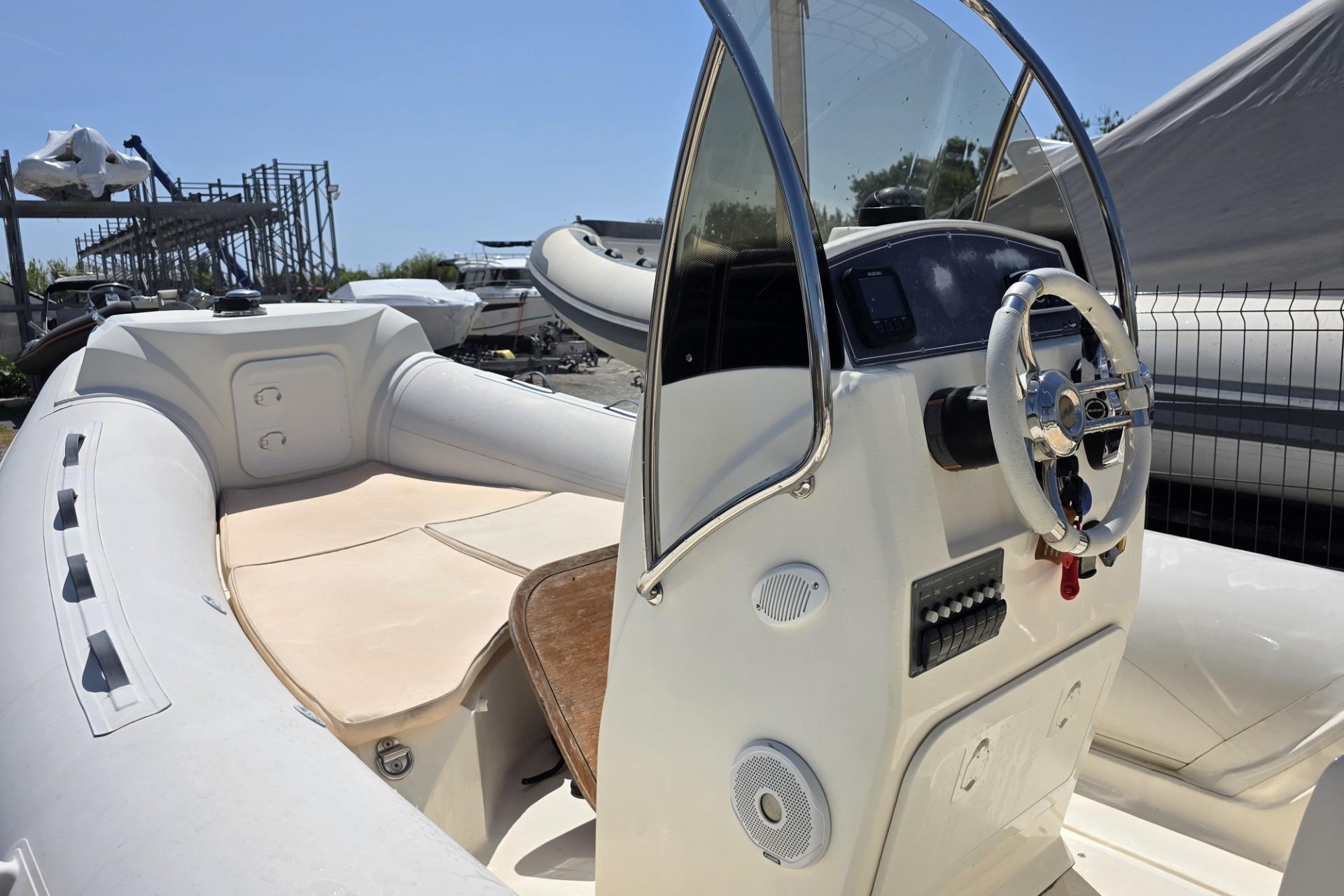 Nuova Jolly 650 boat interior, 2015 model, featuring steering console and seating area.