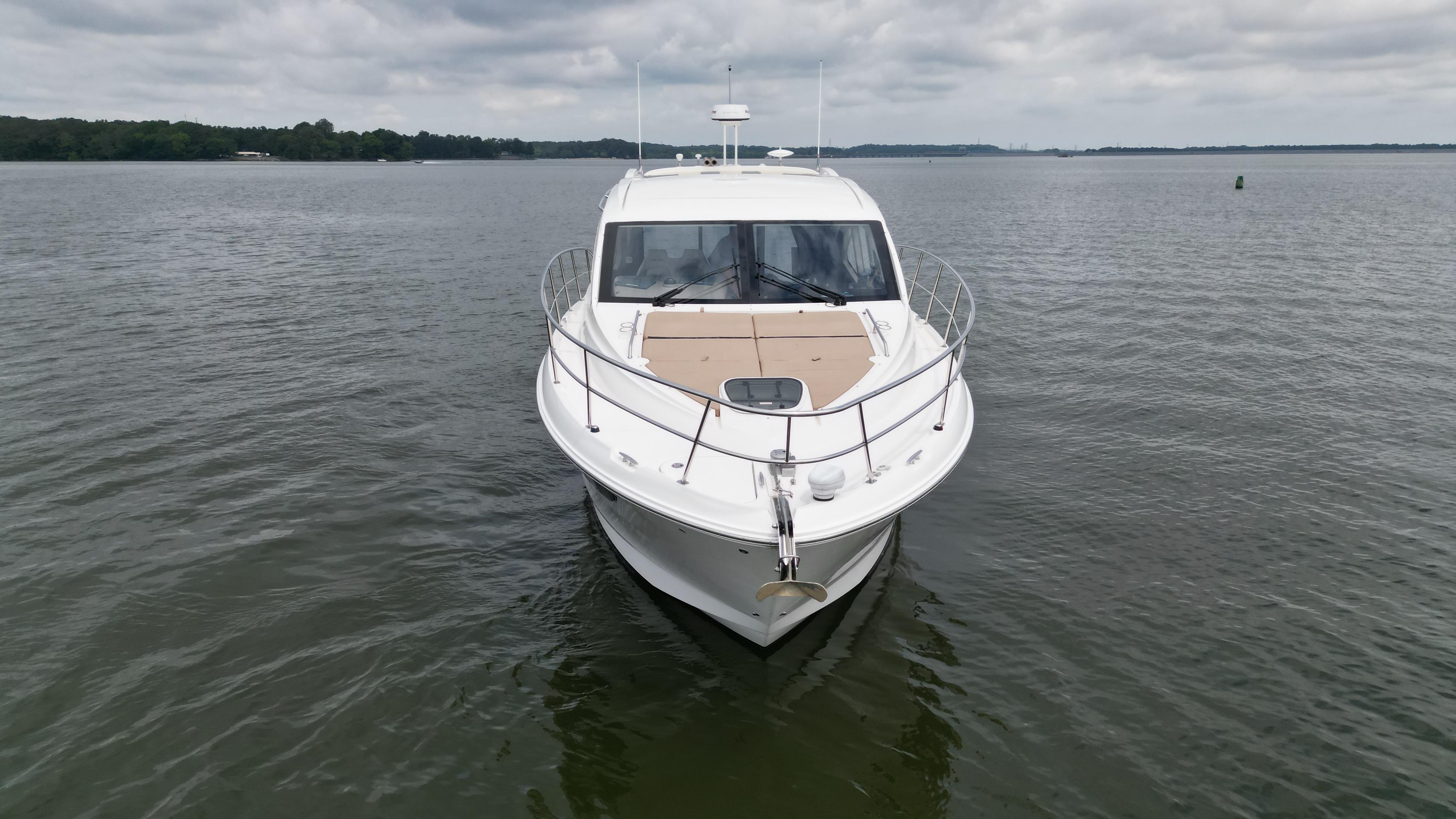 2017 Sea Ray Sundancer 400 yacht on calm water under cloudy sky.