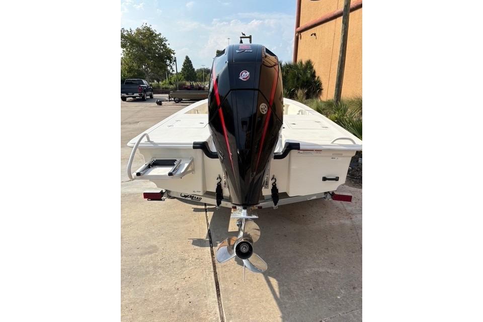 2026 Mako 18 Pro Skiff boat with outboard motor, parked on a trailer.