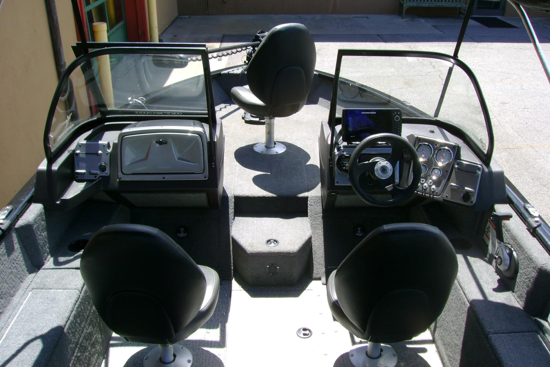 2023 Tracker Pro Guide V-175 WT boat interior with steering console and seating.