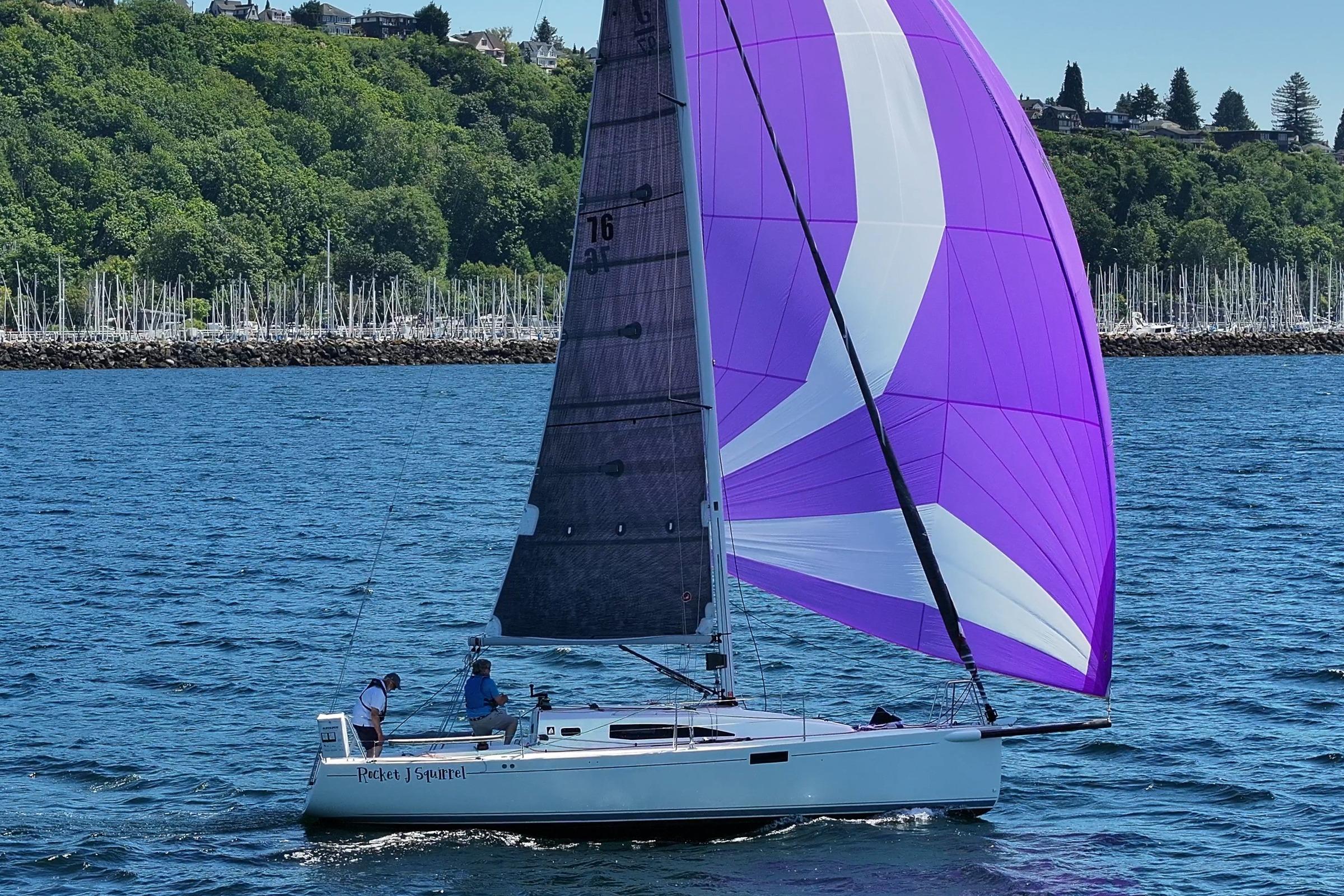 2018 J Boats J/97E sailing with vibrant purple spinnaker on a sunny day.