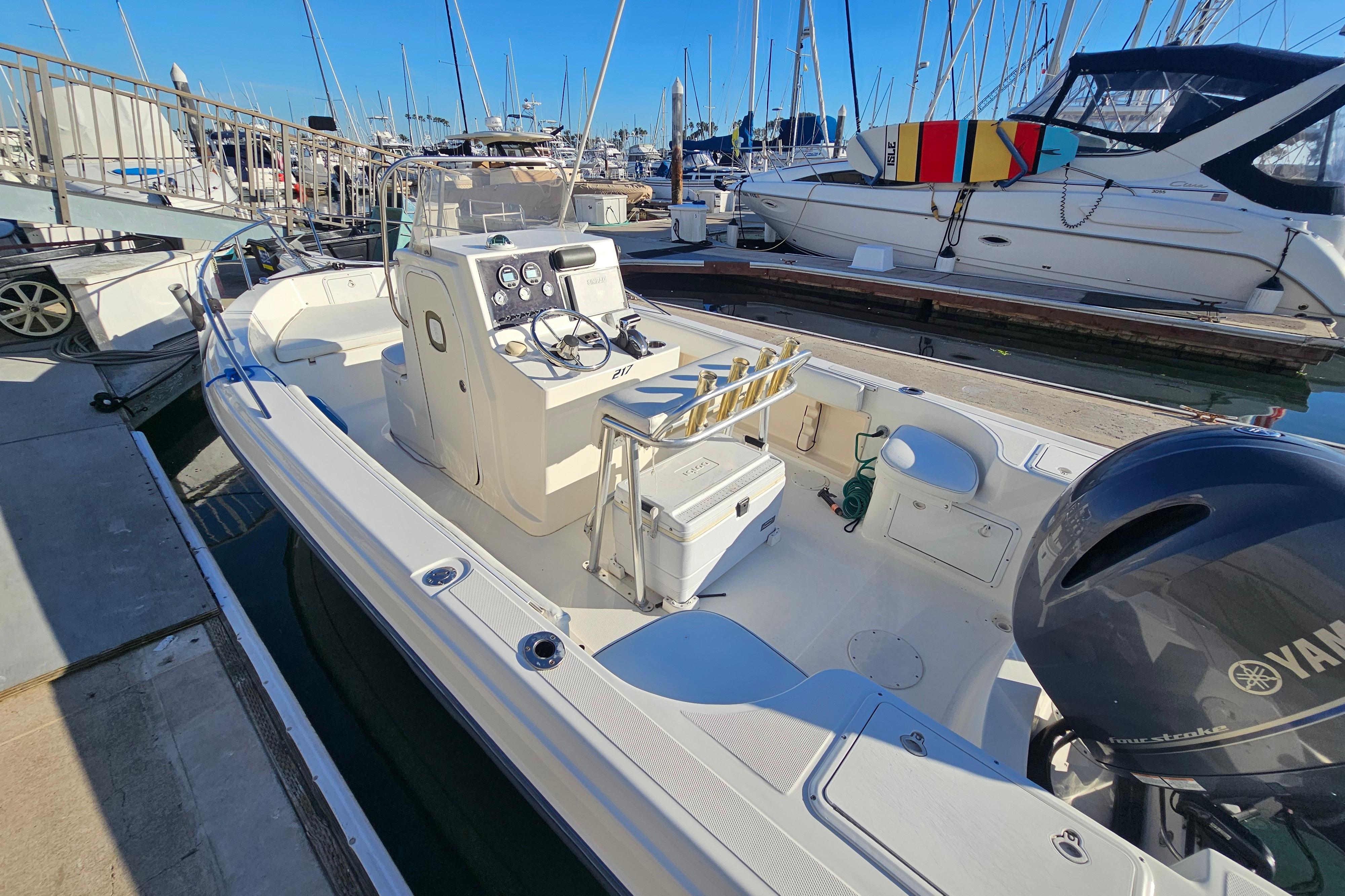 2002 Sea Fox 210 Center Console boat docked at marina, featuring Yamaha outboard engine.