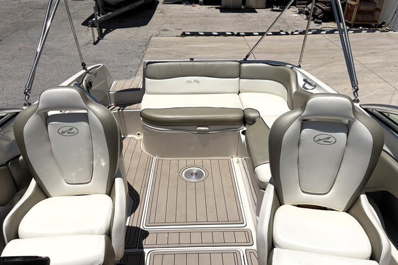 2007 Sea Ray 240 Sundeck interior with beige seating and spacious deck layout.