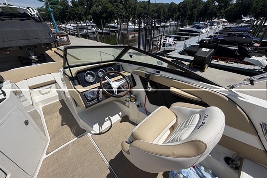 Interior view of 2018 Sea Ray SPX 190 boat at marina dock.