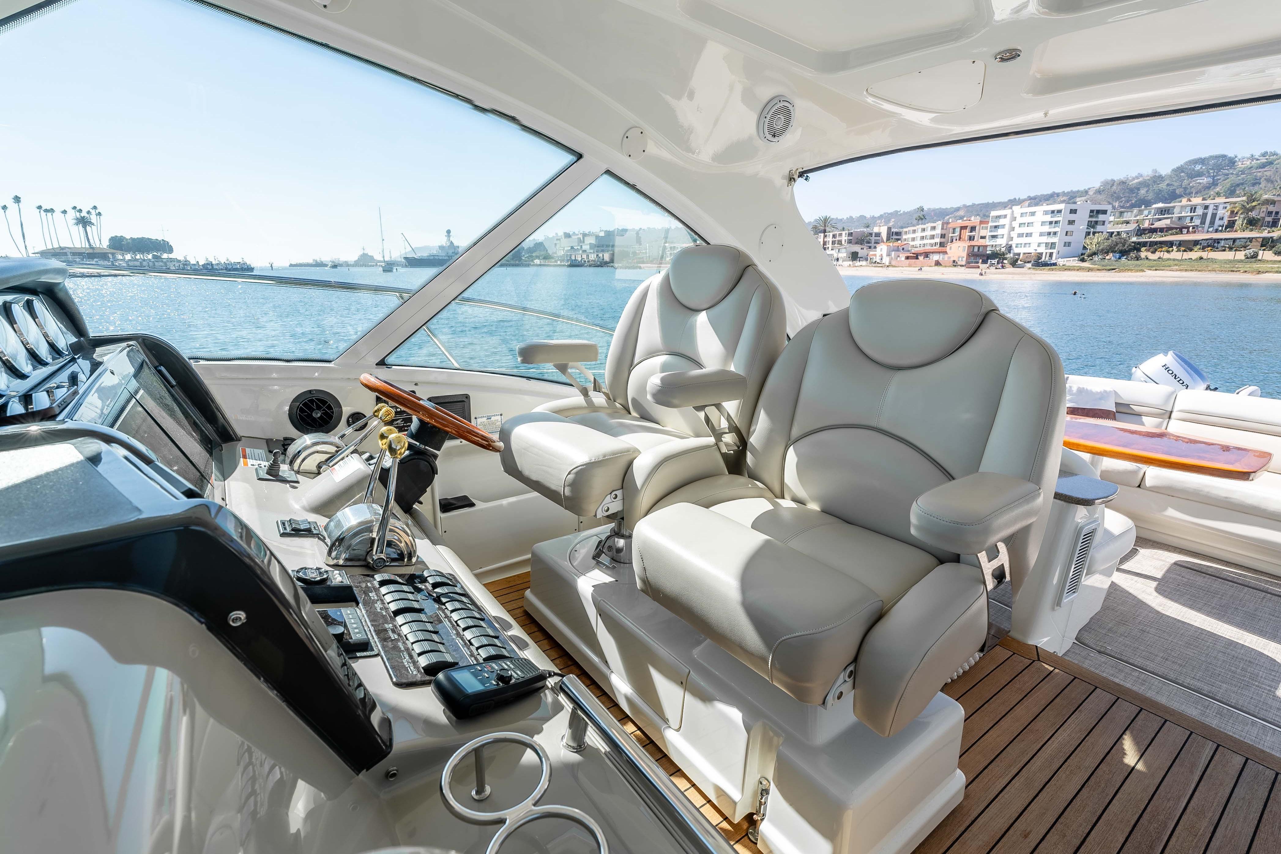 2007 Sea Ray 48 Sundancer helm with luxurious seating and waterfront view.