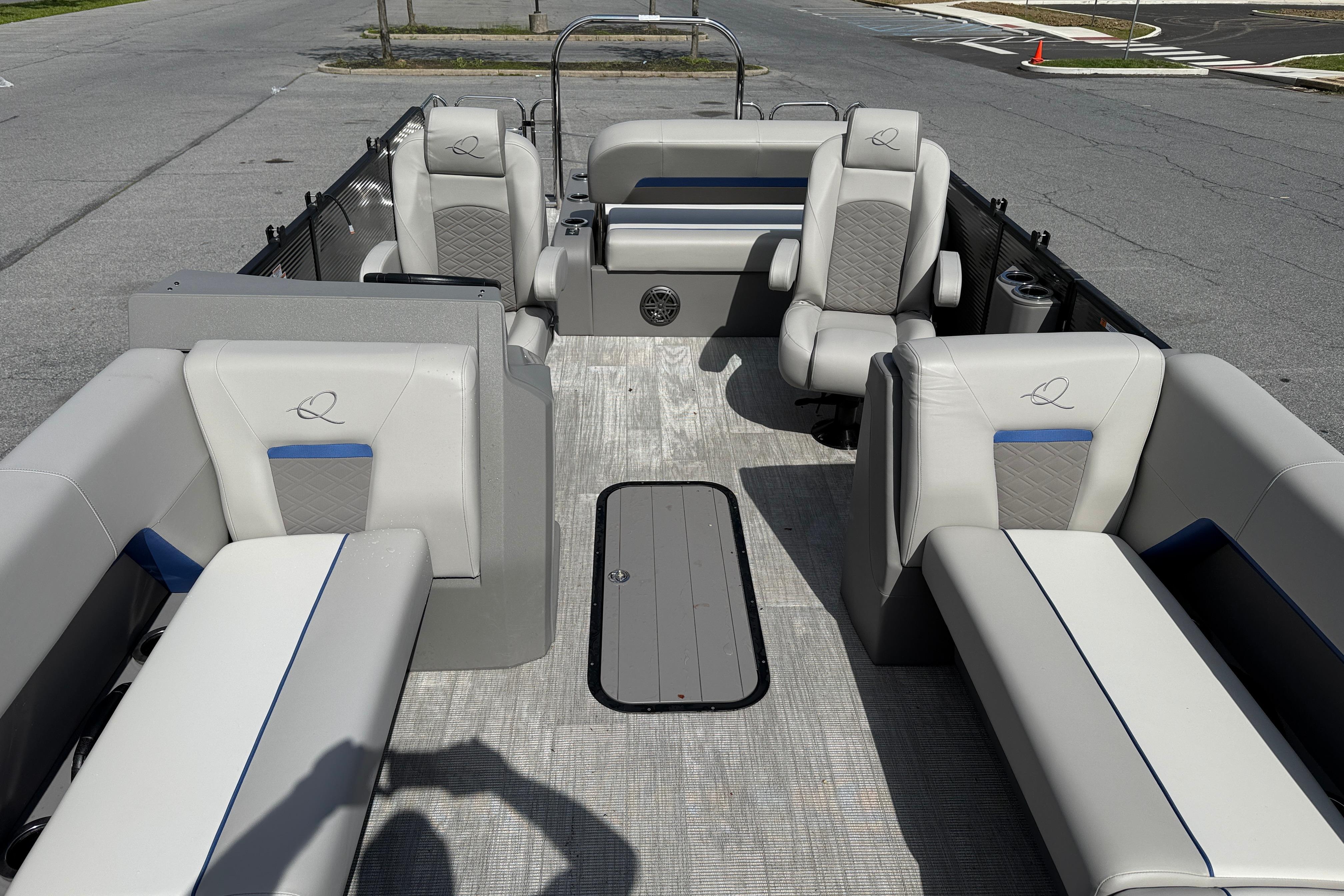 Interior of 2025 Qwest Splash Pad E-Class pontoon boat with luxurious seating.