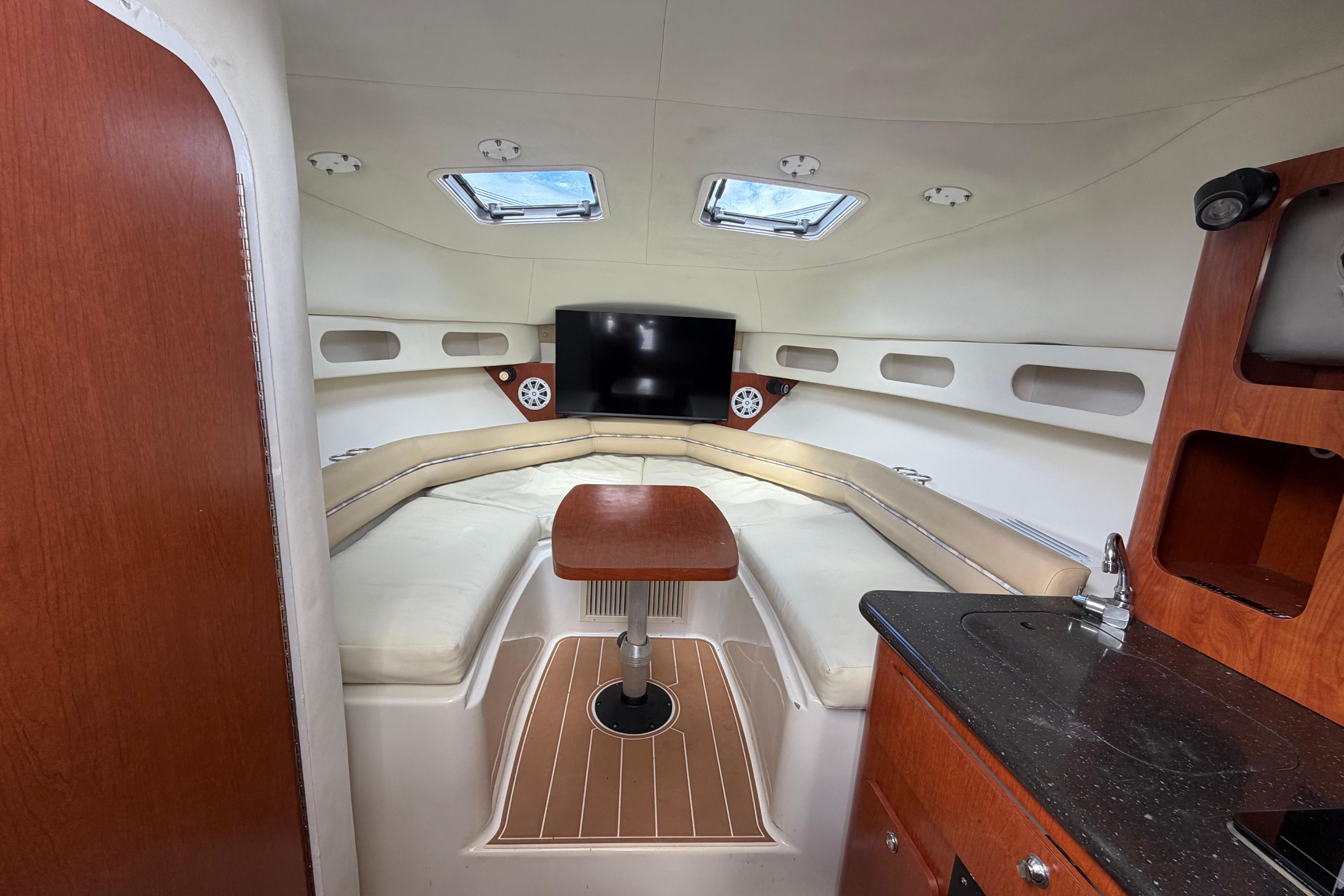 Interior of 2007 Pro-Line 32 Express boat with seating, table, and kitchenette.