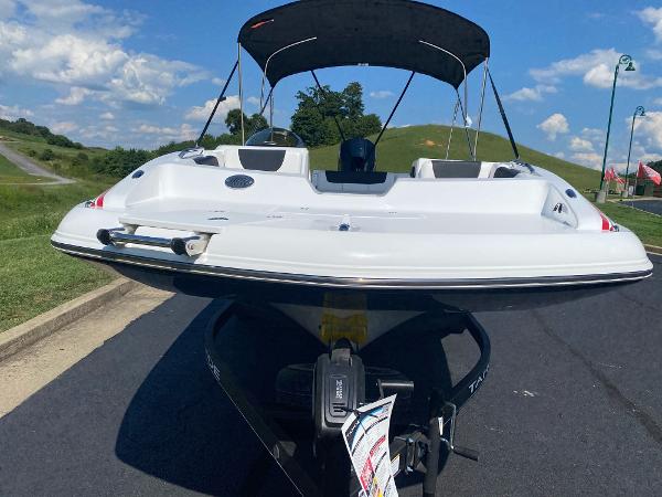 2024 Tahoe 2150 boat with canopy on a sunny day, parked on a road.