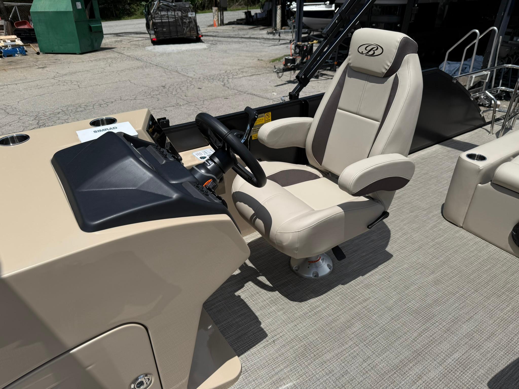2026 Bentley Pontoons Legacy 243 Swingback captain's chair and helm, featuring luxurious design.