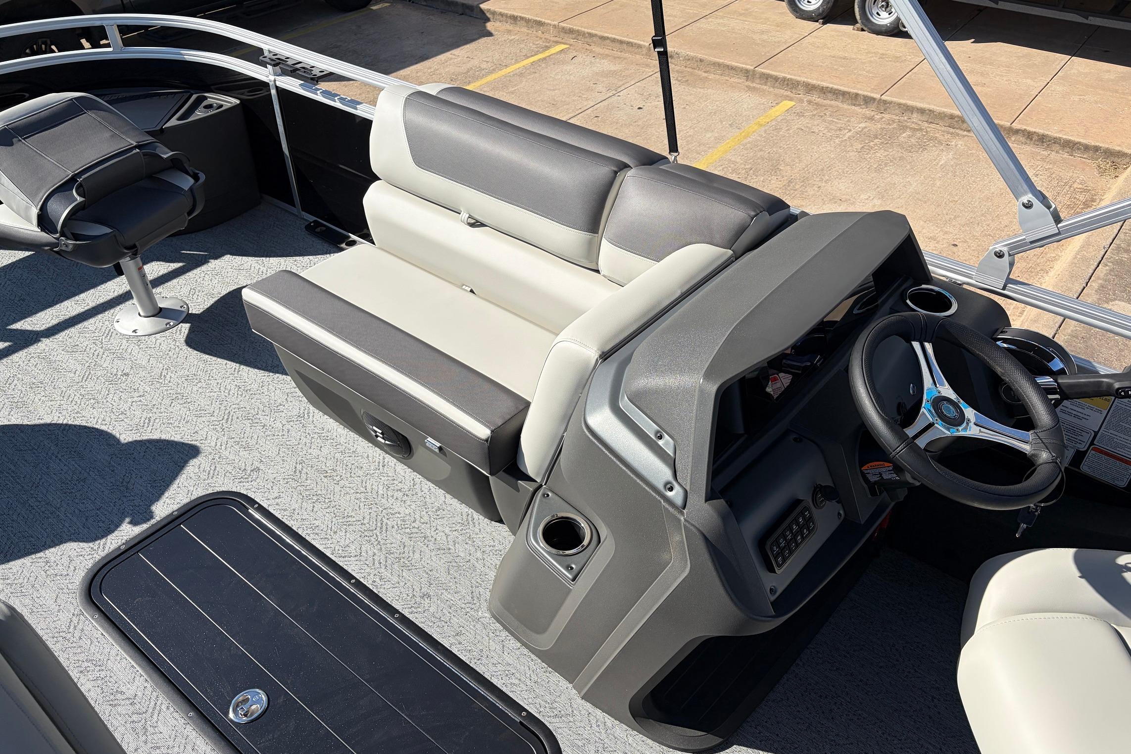 2026 Sun Tracker Fishin' Barge 22 XP3 interior with steering console and seating.