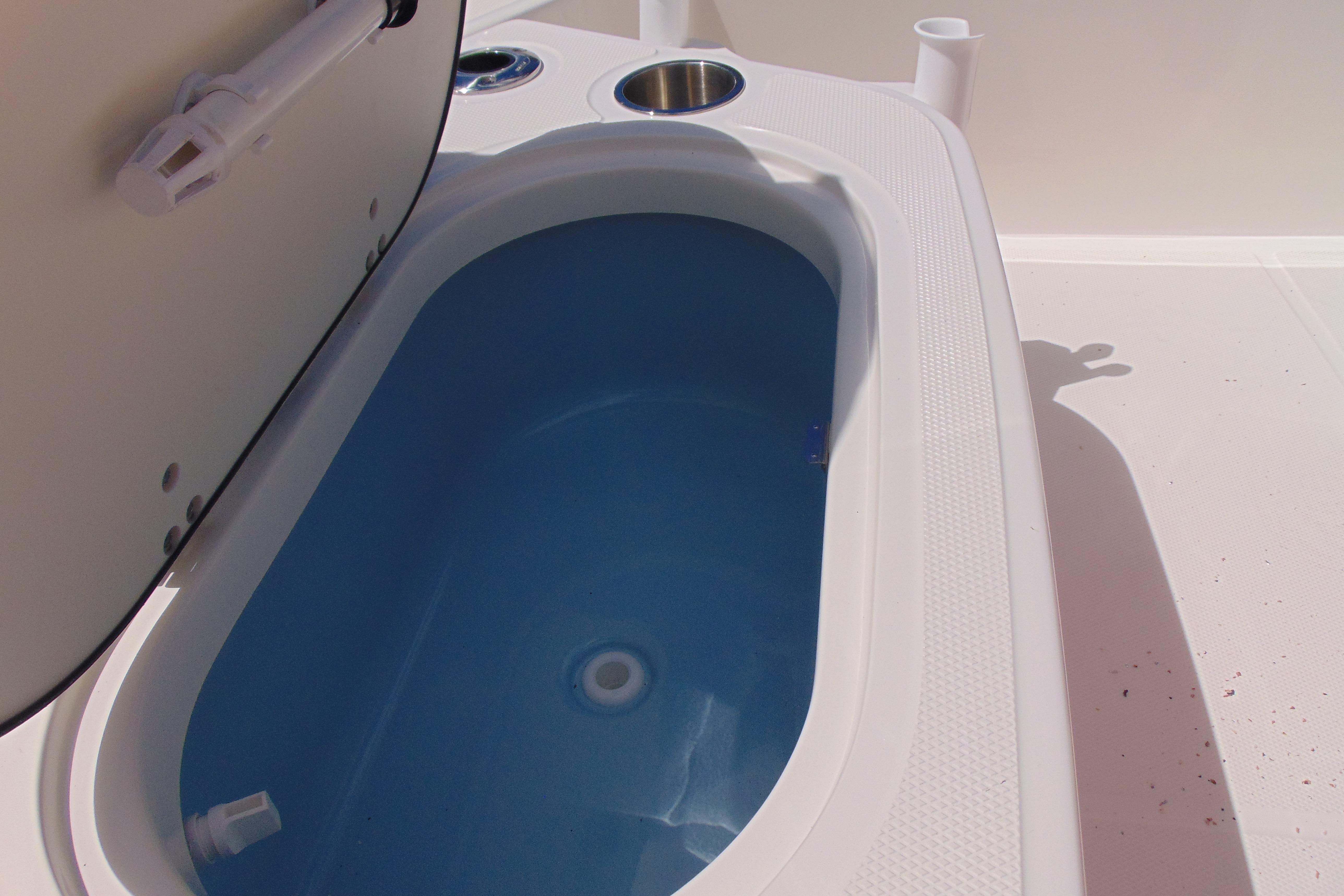 Livewell on 2026 Boston Whaler 150 Montauk boat, open lid, blue interior.