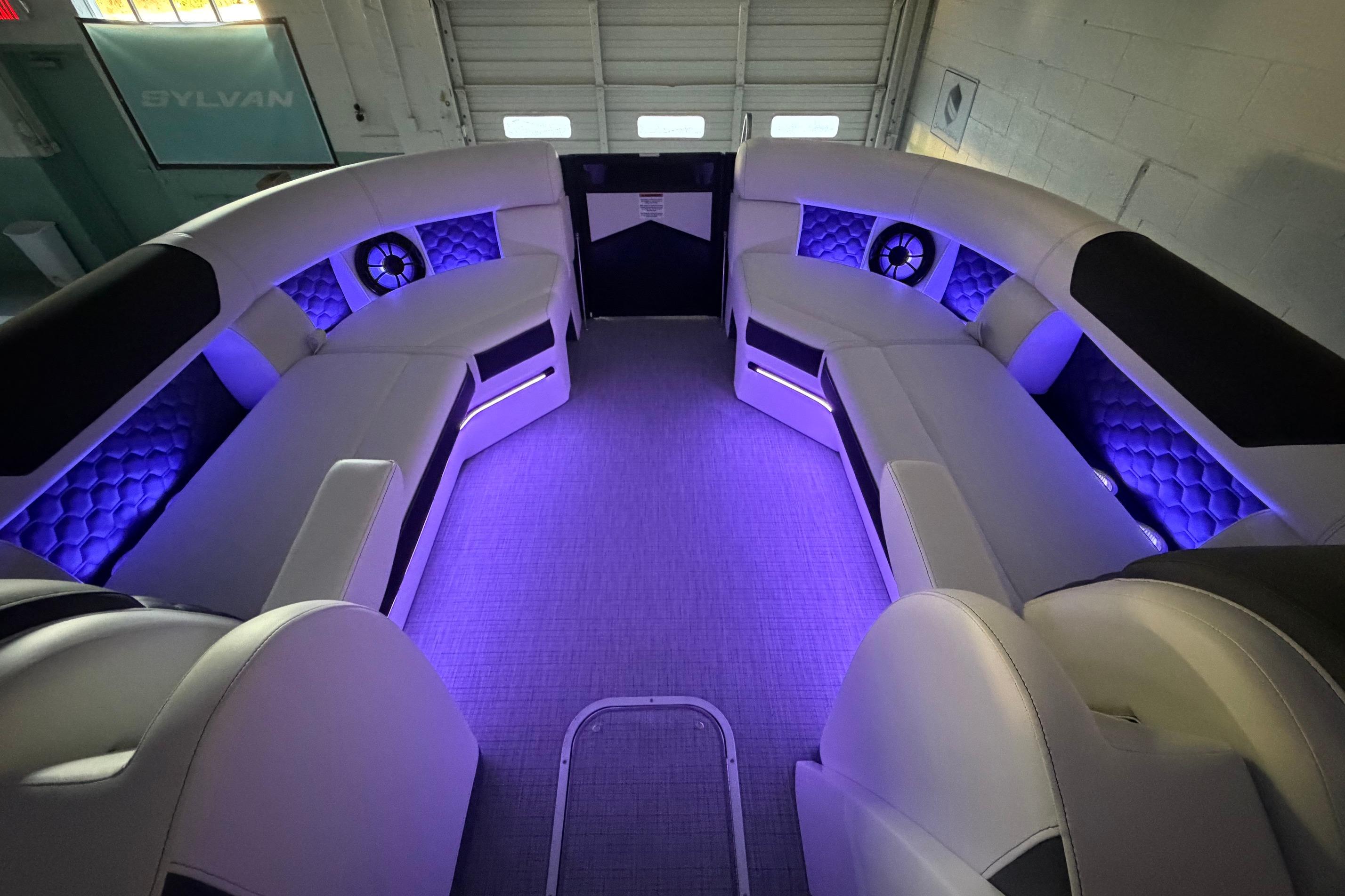 Luxurious interior of 2026 South Bay 525SB2 pontoon boat with ambient purple lighting.