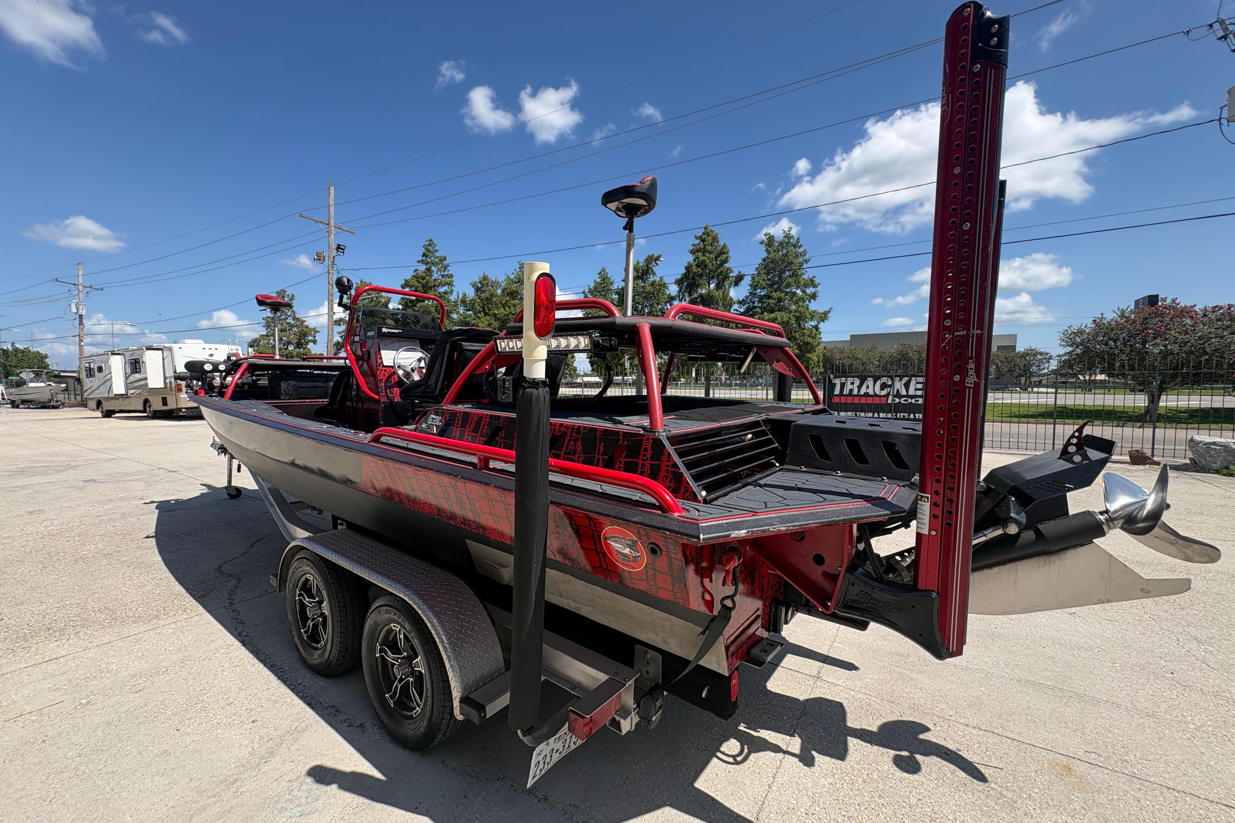 Custom 2018 Swamp Shark 24' boat on trailer, parked outdoors under blue sky.