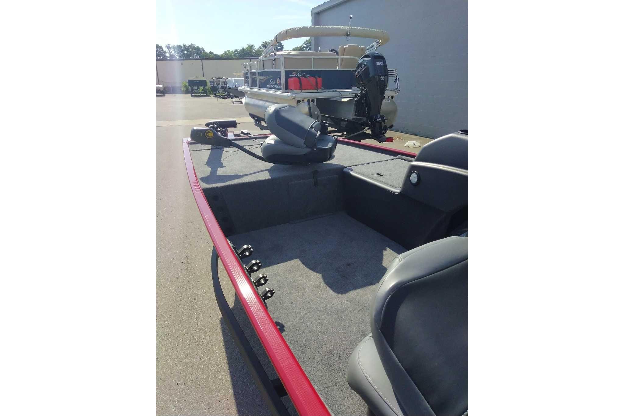 2026 Tracker Bass Tracker Classic XL boat with red trim, parked outdoors.