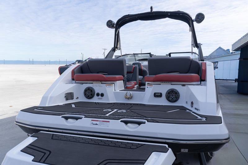 2026 Scarab 255 LX Wake boat, rear view, featuring sleek design and modern seating.