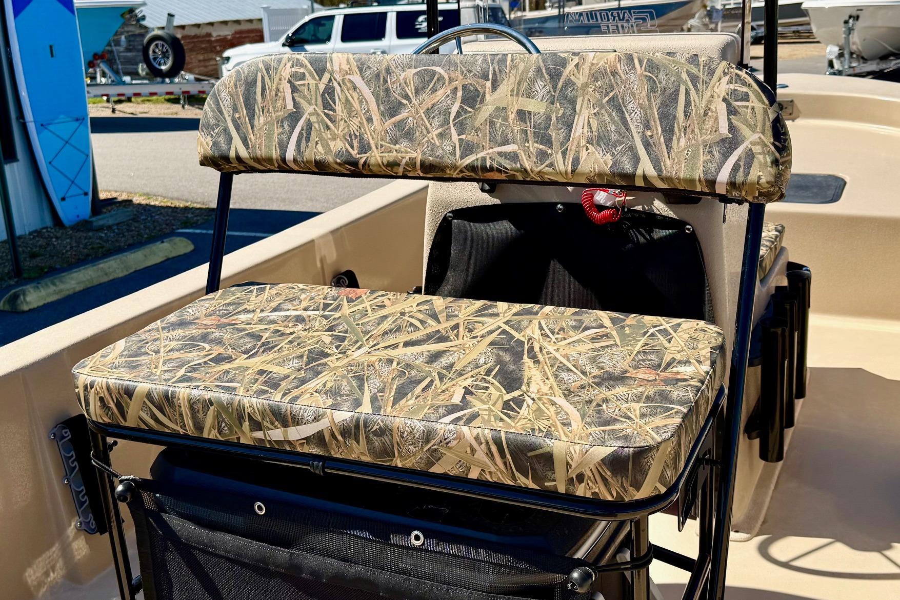 2026 Carolina Skiff E18 JVX CC boat seat with camouflage pattern.