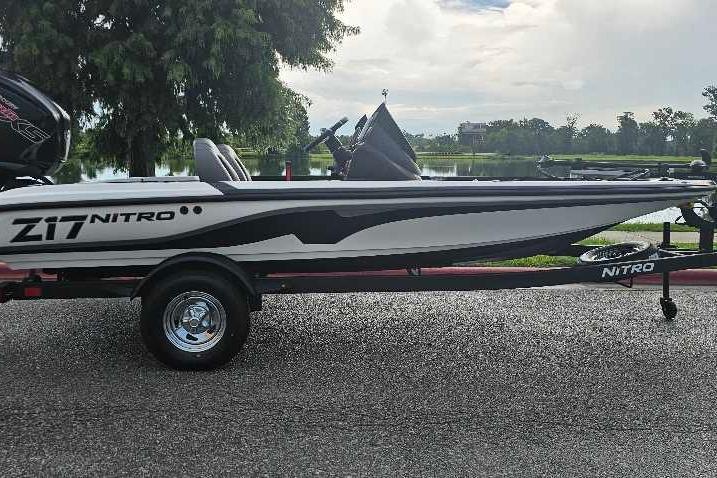 2026 Nitro Z17 boat on trailer by a lake, showcasing sleek design and modern features.