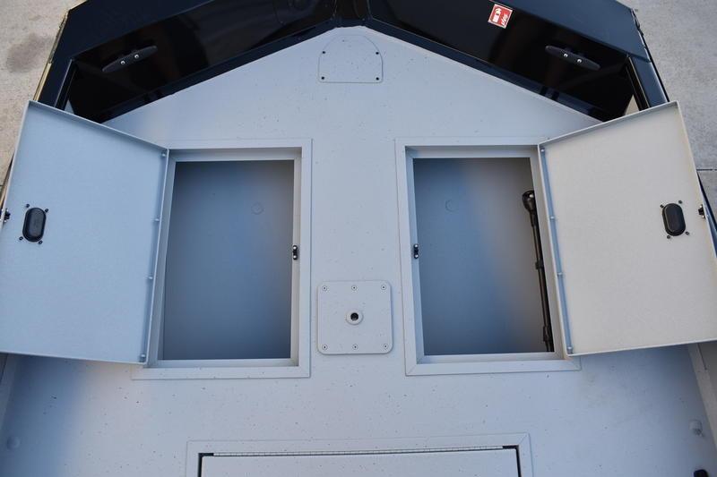 2026 Lowe Roughneck RX1760 Pathfinder boat storage compartments open on deck.
