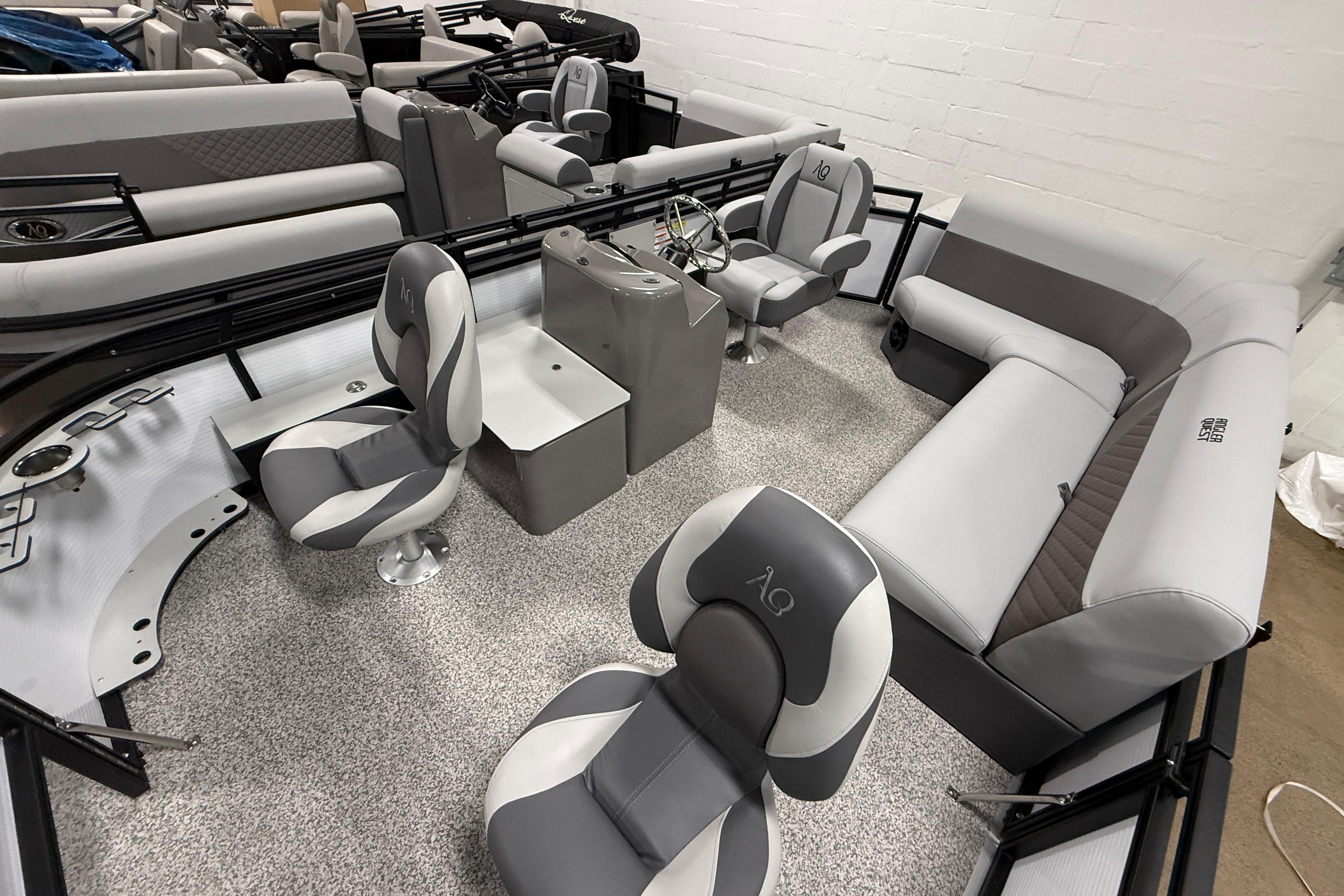 2026 Angler Quest 816 Panfish boat interior with gray seating and steering console.