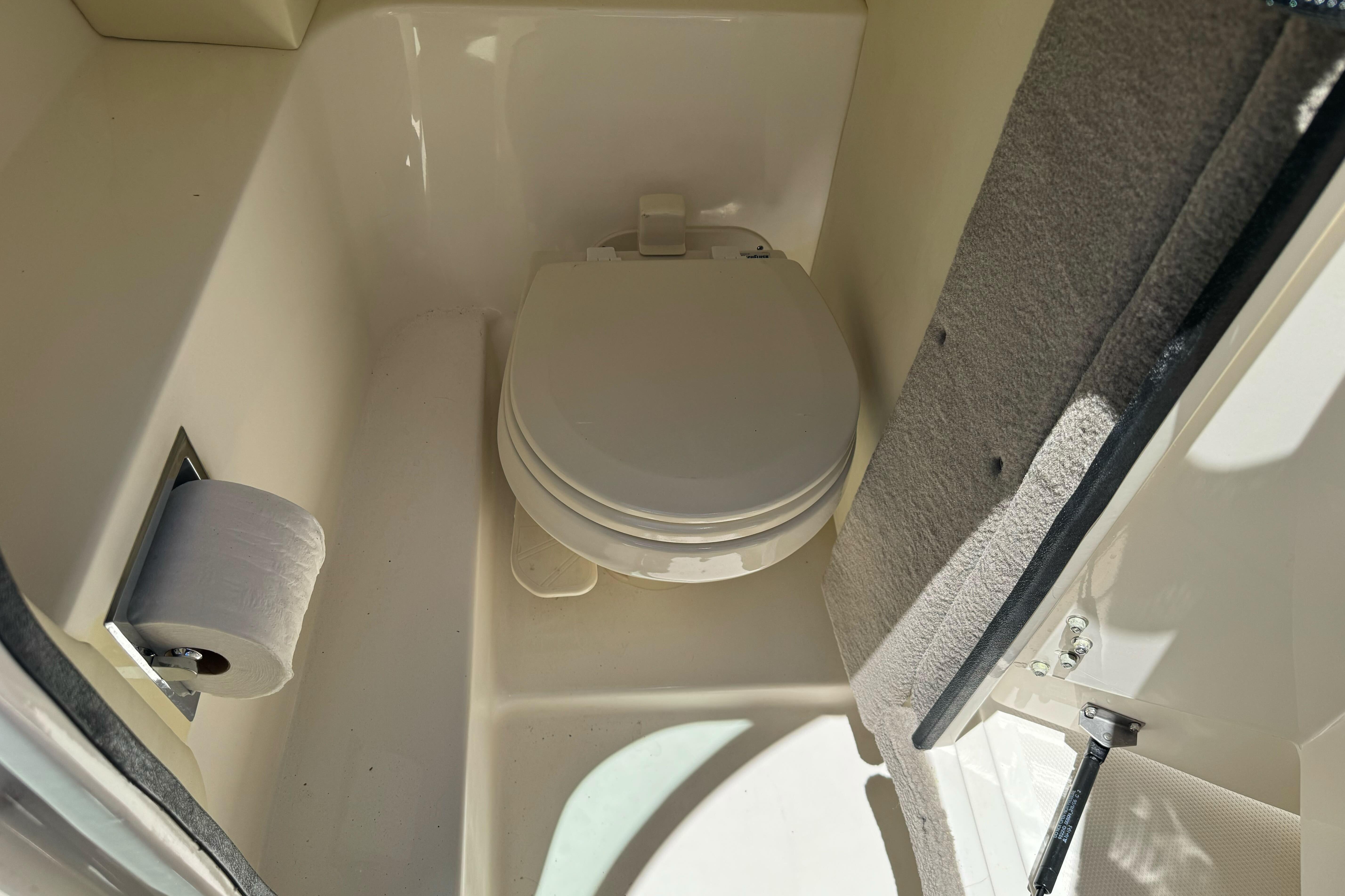 2007 Sea Ray SLX 250 boat bathroom with toilet and toilet paper holder.