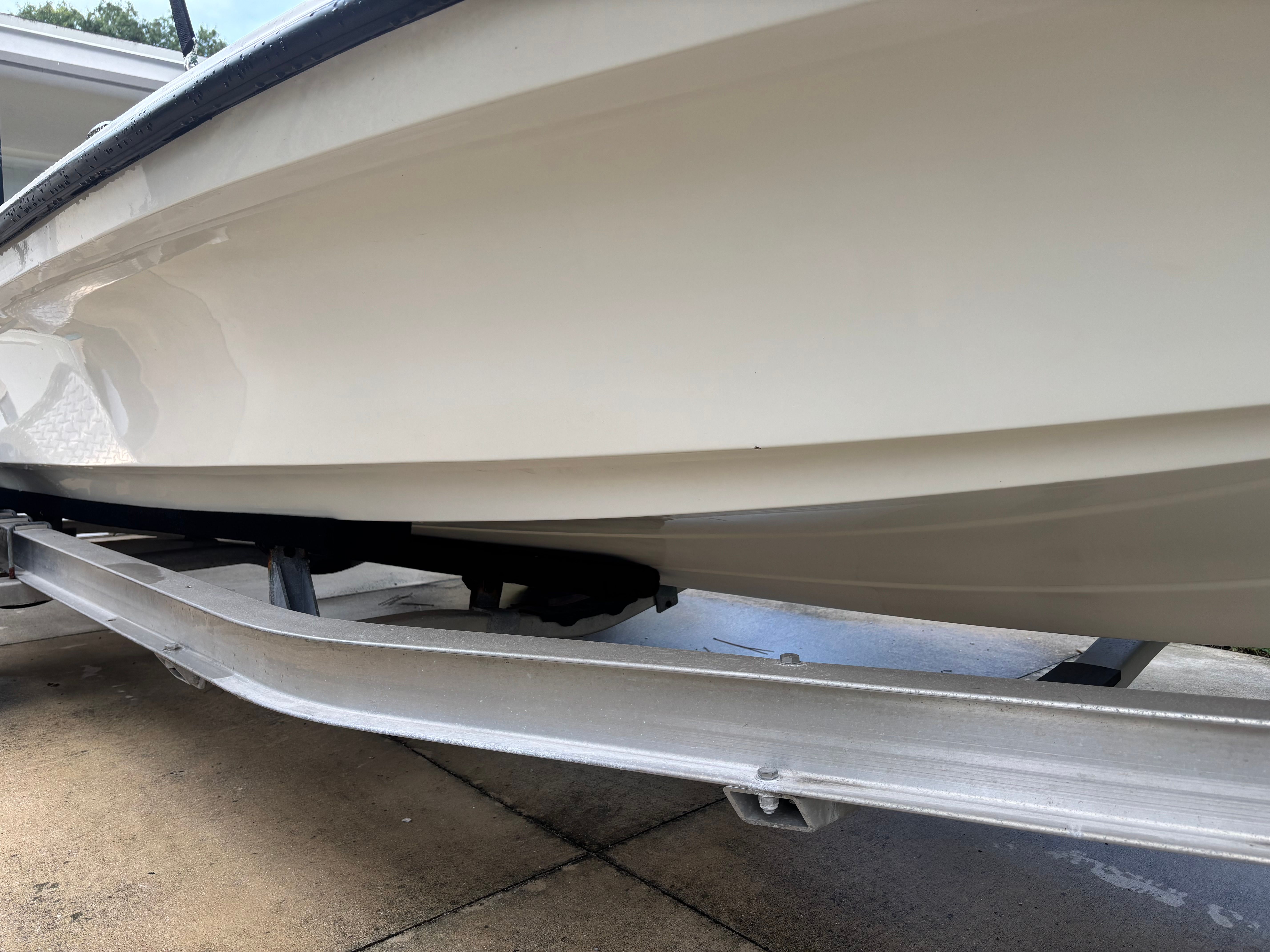 Close-up of a white Mako 18 LTS boat hull on a trailer.