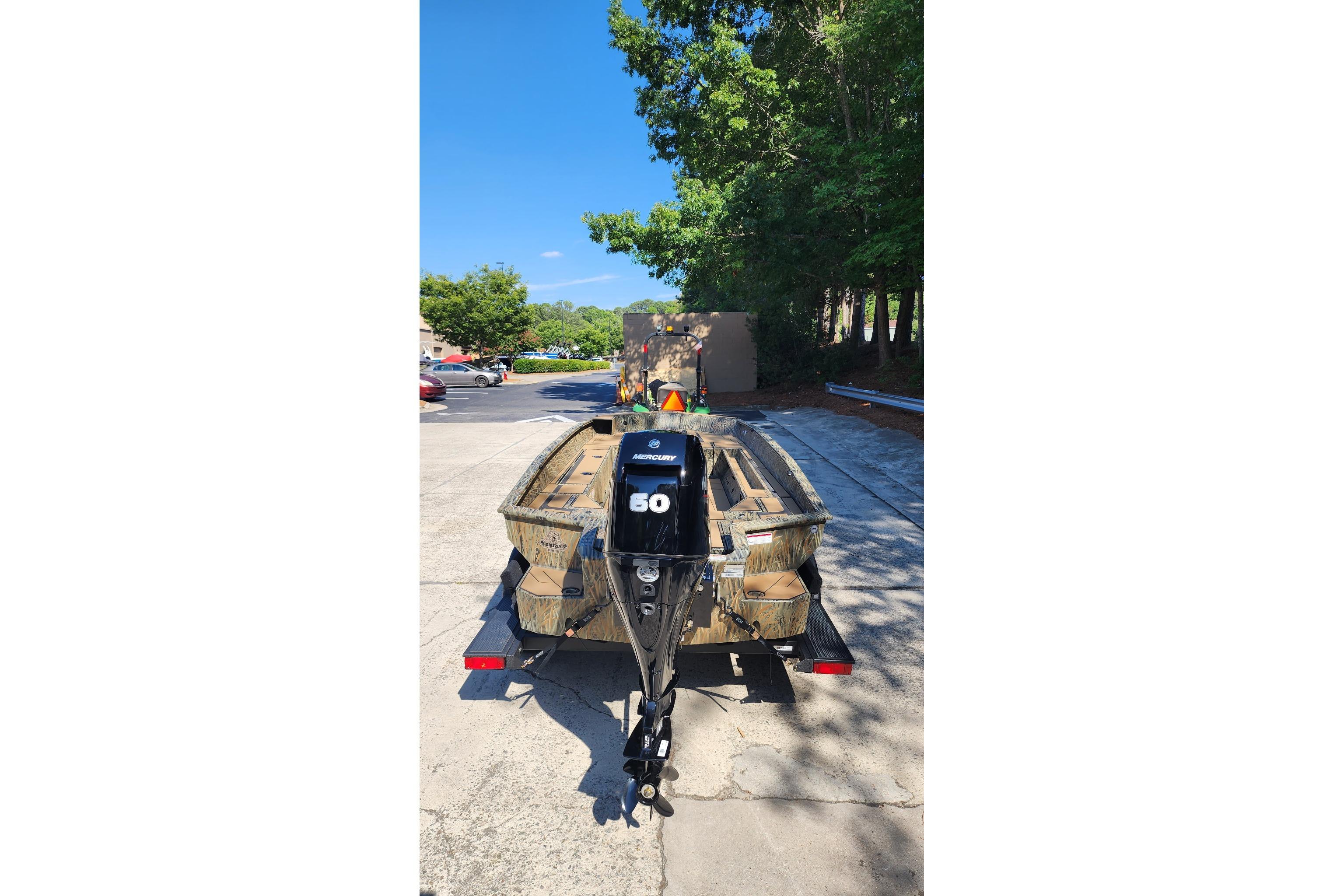 2026 Tracker Grizzly 1756 T Marsh boat with Mercury 60 engine on trailer.