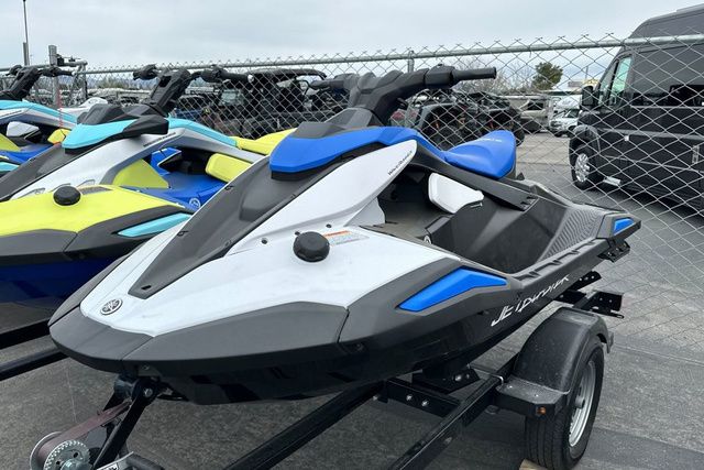 A Yamaha WaveRunner Jetblaster in black and blue sits on a trailer next to other watercraft.