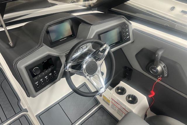 2025 Cobalt CS23 Surf boat dashboard with modern controls and steering wheel.