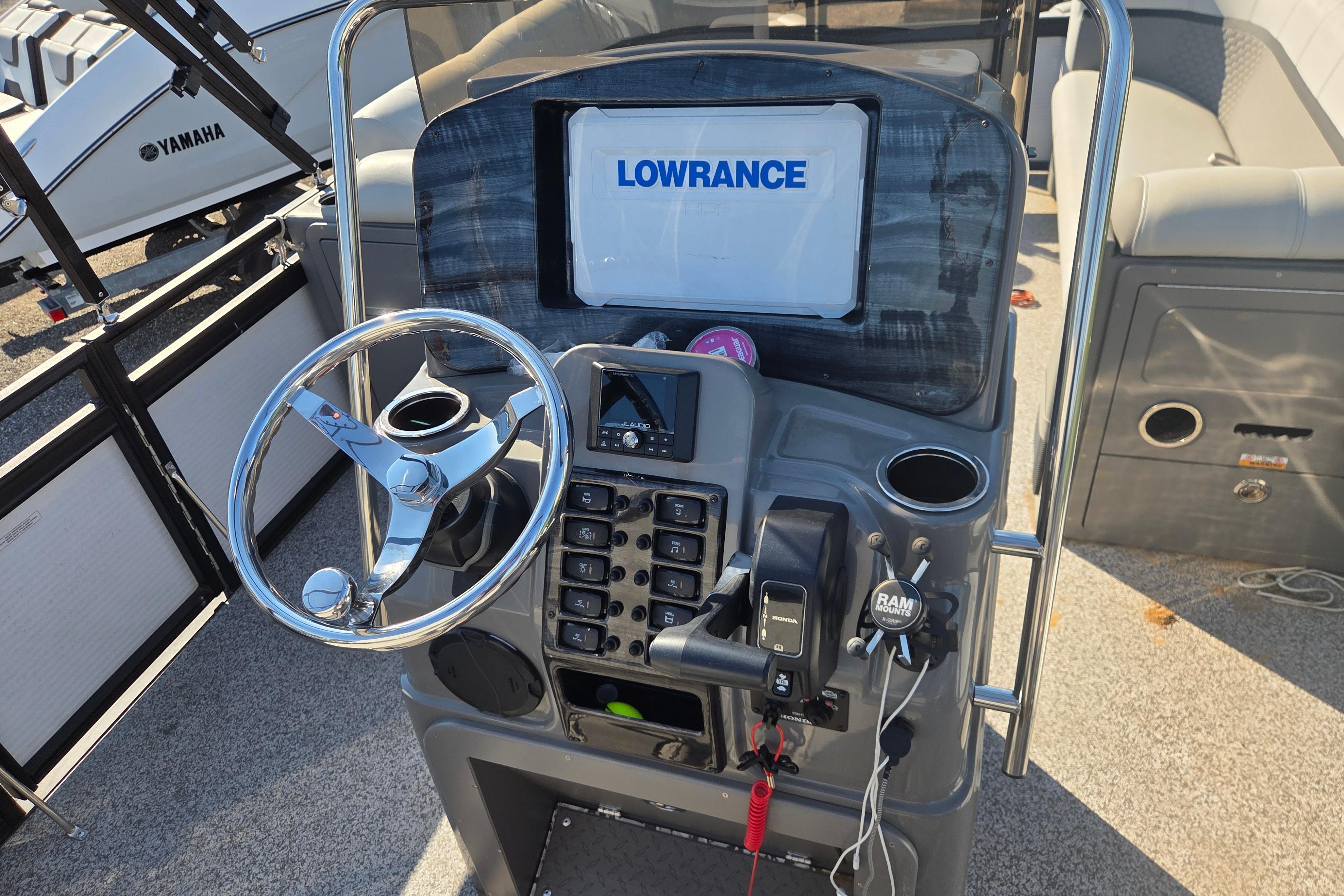 2024 Angler Qwest 8526 Pro Troll boat dashboard with Lowrance display and steering wheel.