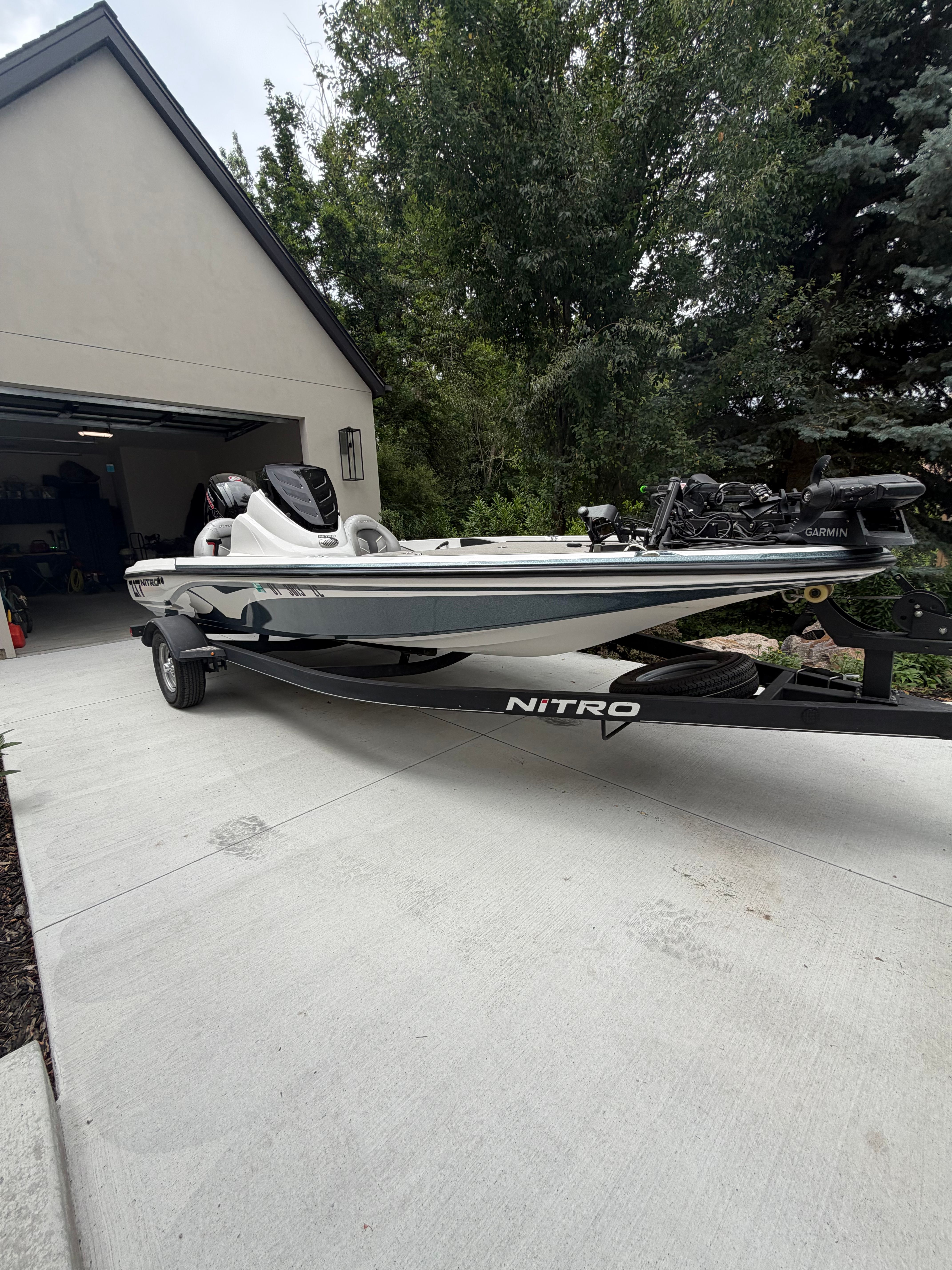 A 2020 Nitra Boats Z17 on a trailer in front of a garage.