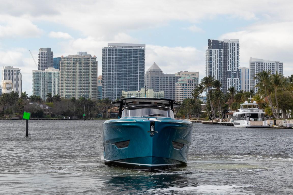 2024 Solaris Power 52 Open yacht cruising in urban waterfront.