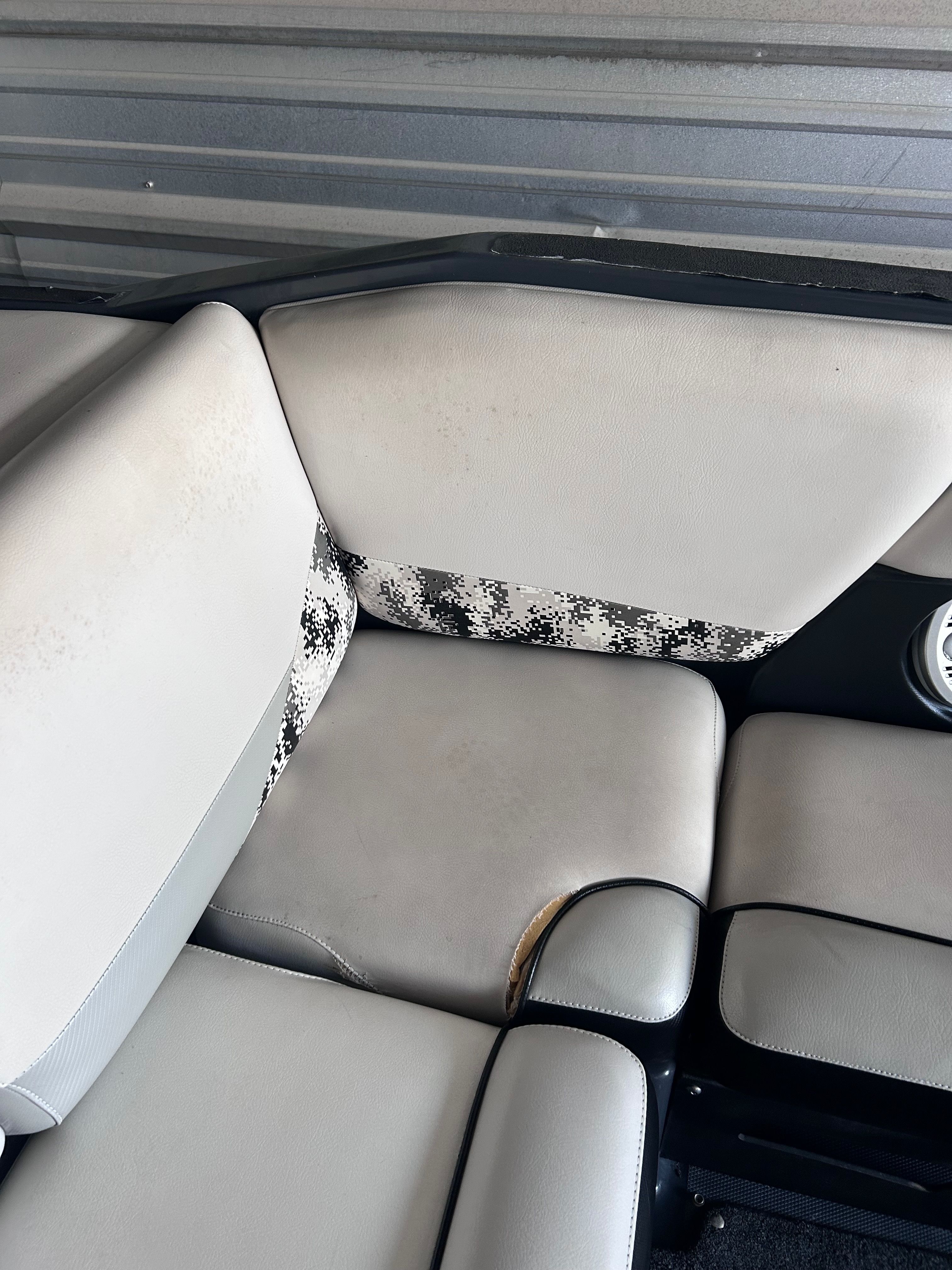 Interior of a 2013 Axis A22 with worn seats.