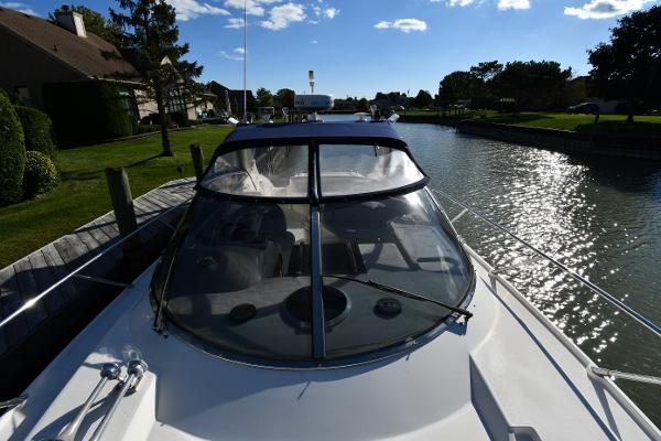 1997 Sunseeker Camargue 47 yacht docked on a sunny canal with clear skies.