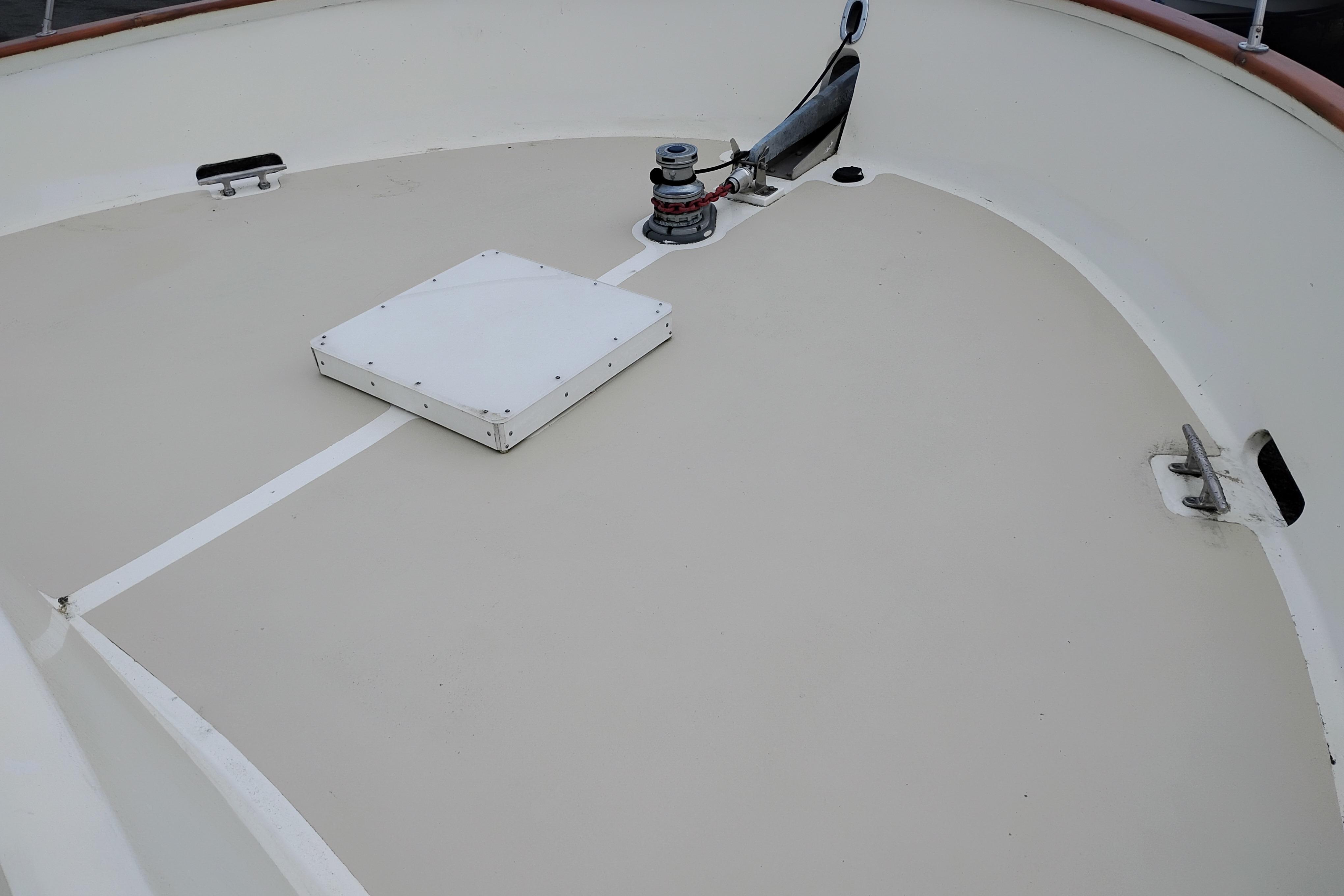 Deck of 1977 Custom International Offshore 65 boat with winch and hatch.