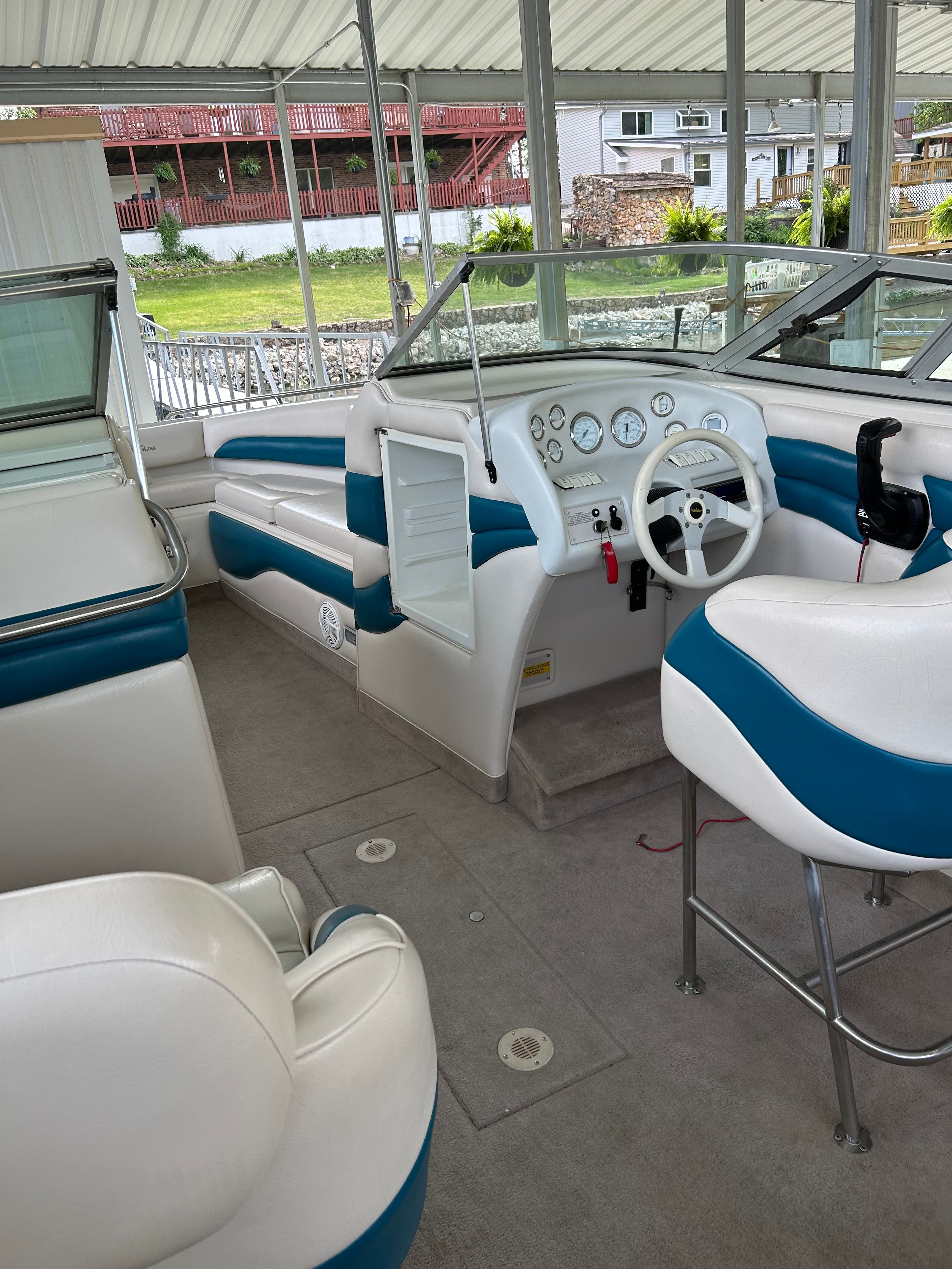 Interior of a 1995 Crownline 266 BR boat with blue and white seating.