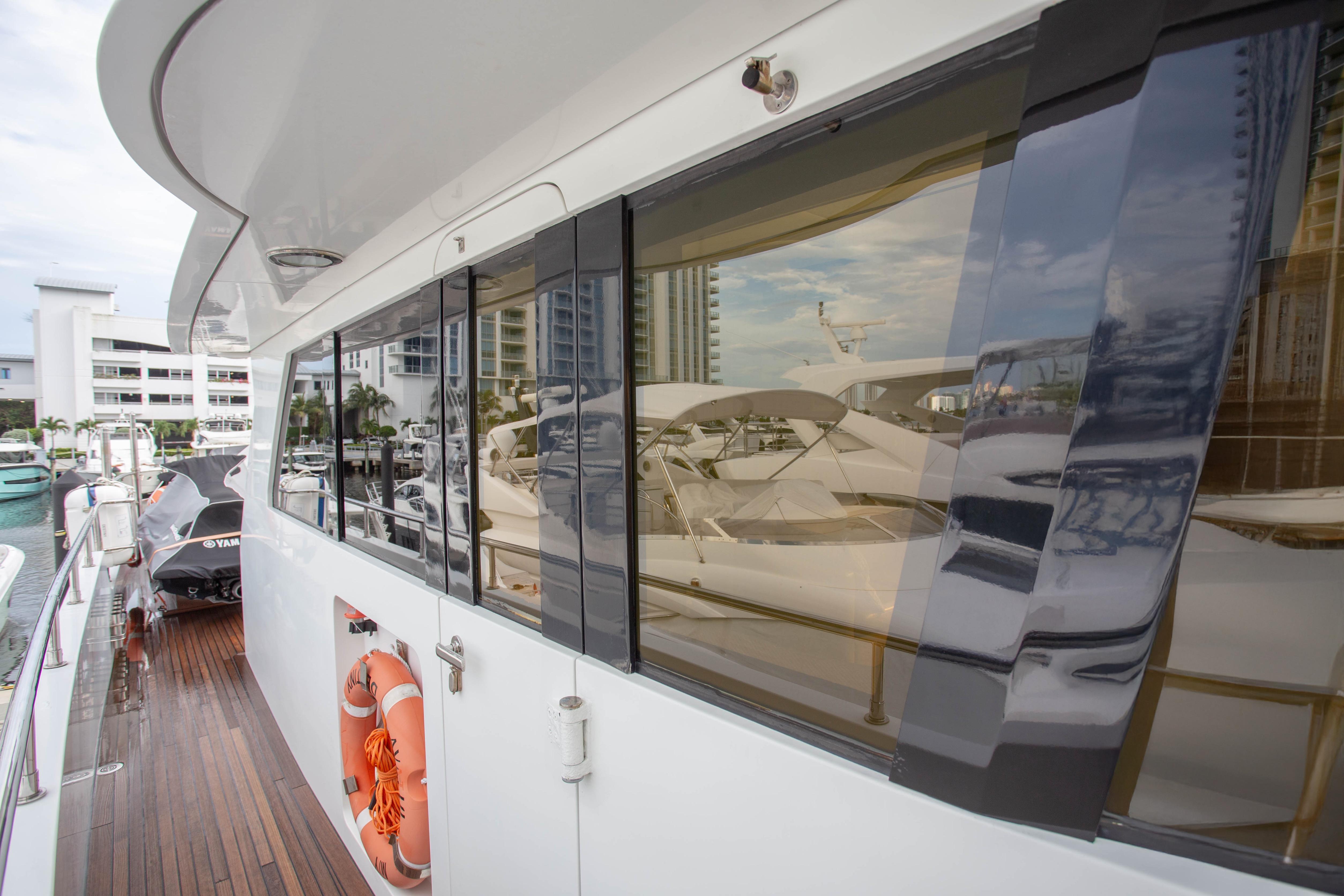 Side view of 2014 Fifth Ocean Yachts 24m Displacement Explorer Yacht docked at marina.