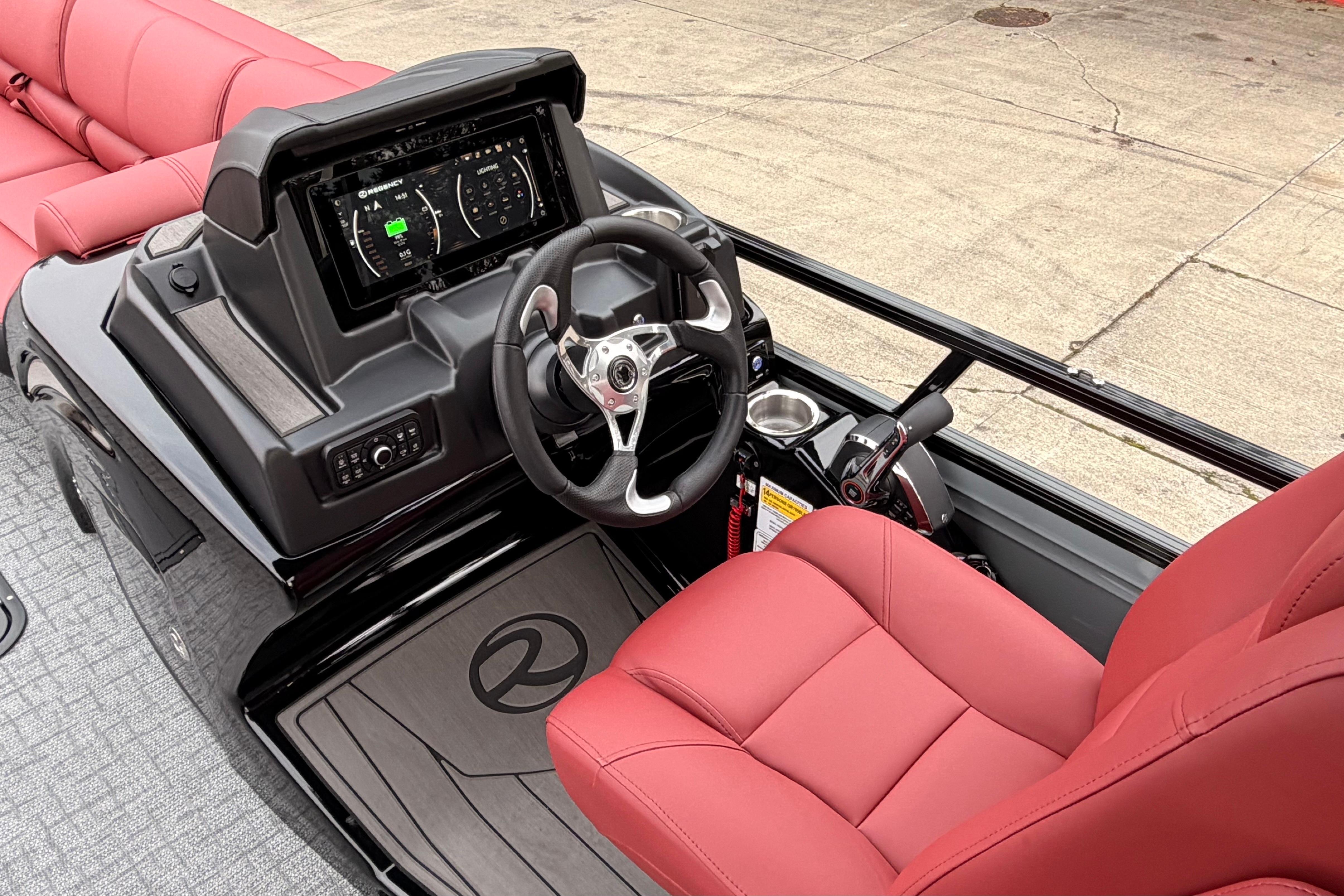 2026 Regency 250 DL boat cockpit with red seating and modern dashboard.