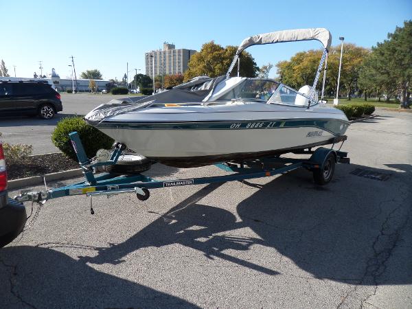 1992 Rinker Captiva 170 OB boat on trailer in parking lot.