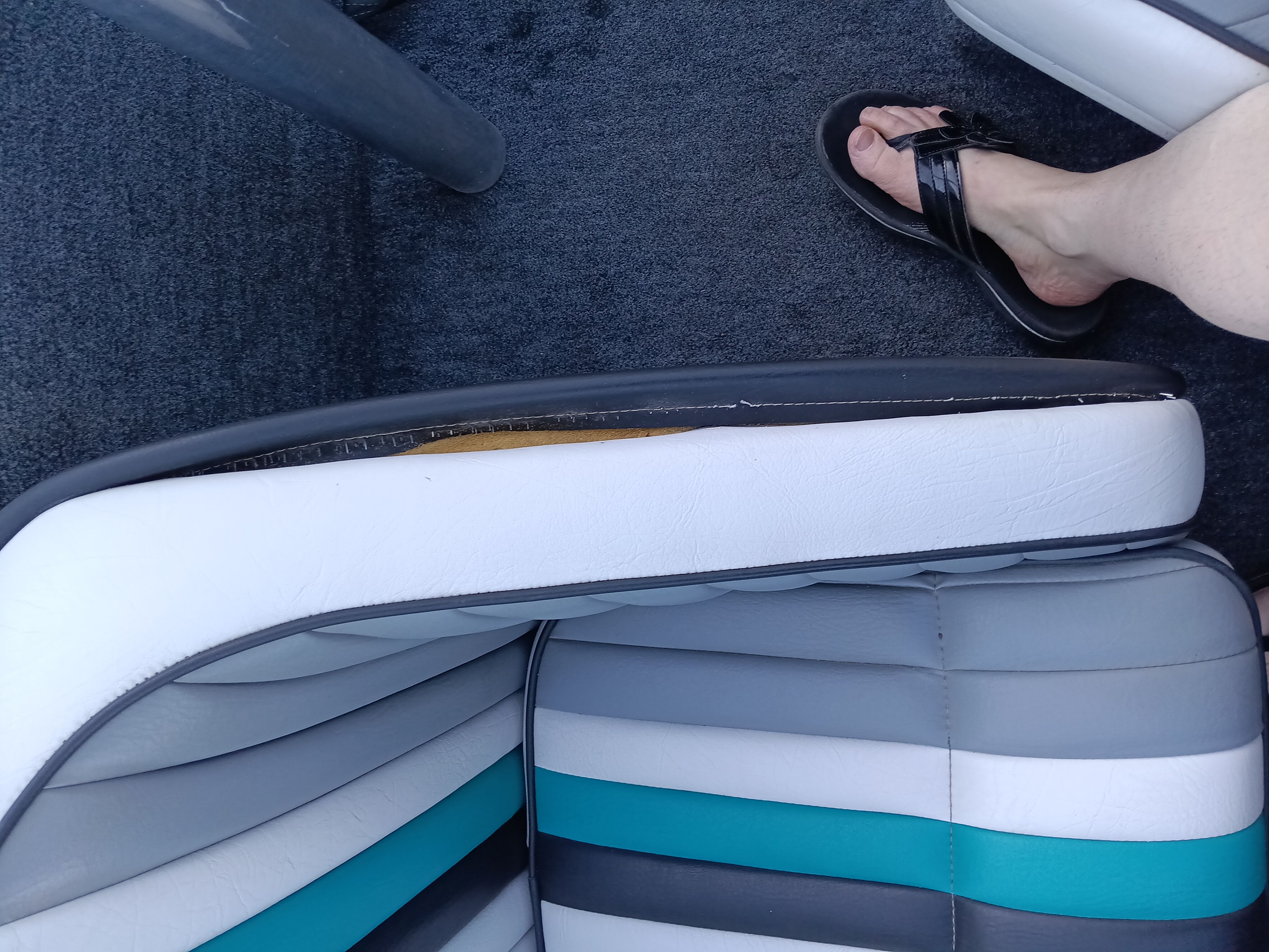 Interior of a 1991 Malibu Skier boat with worn seat.