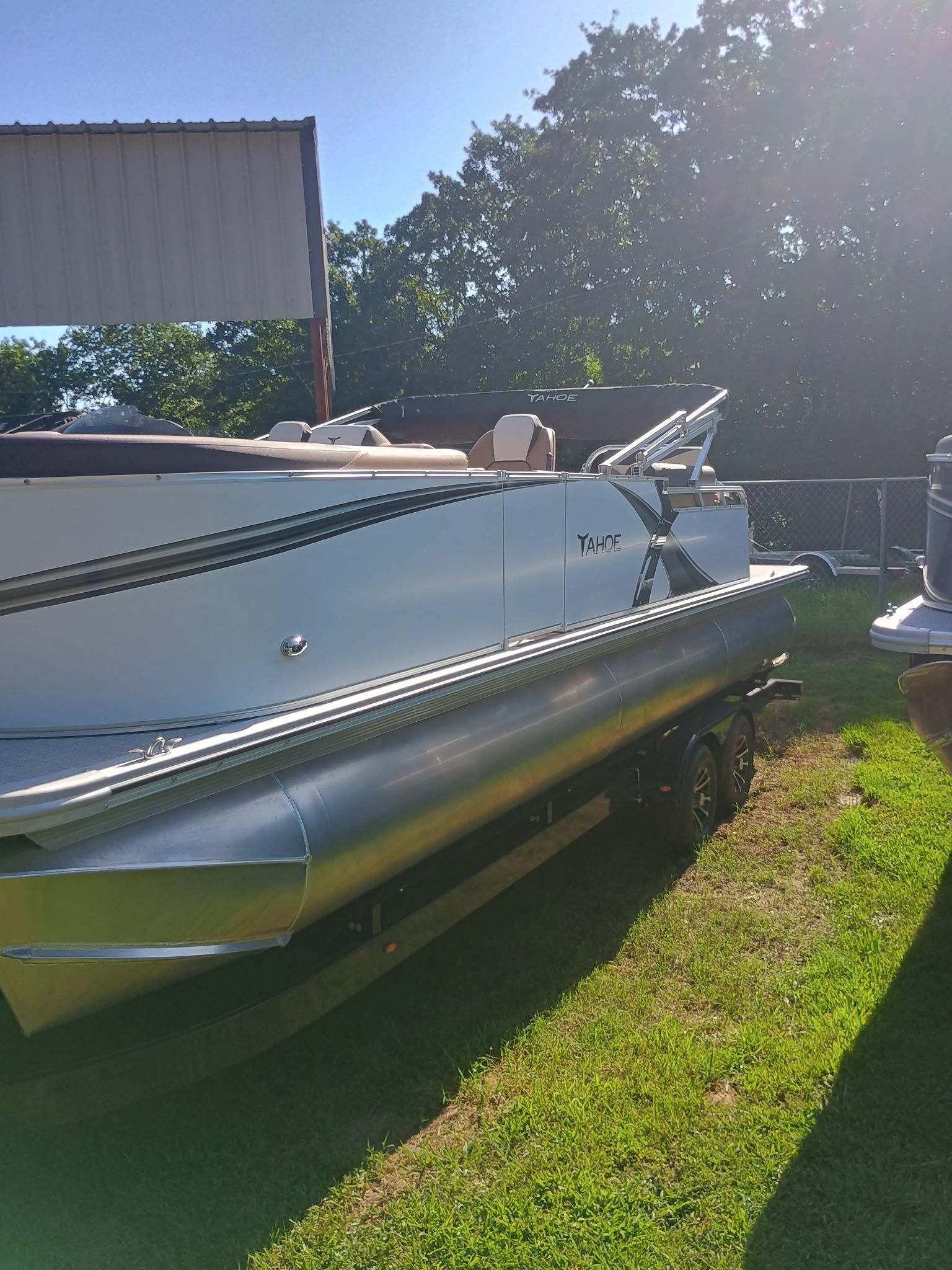 2025 Tahoe LTZ Quad Lounger Shift pontoon boat parked outdoors.