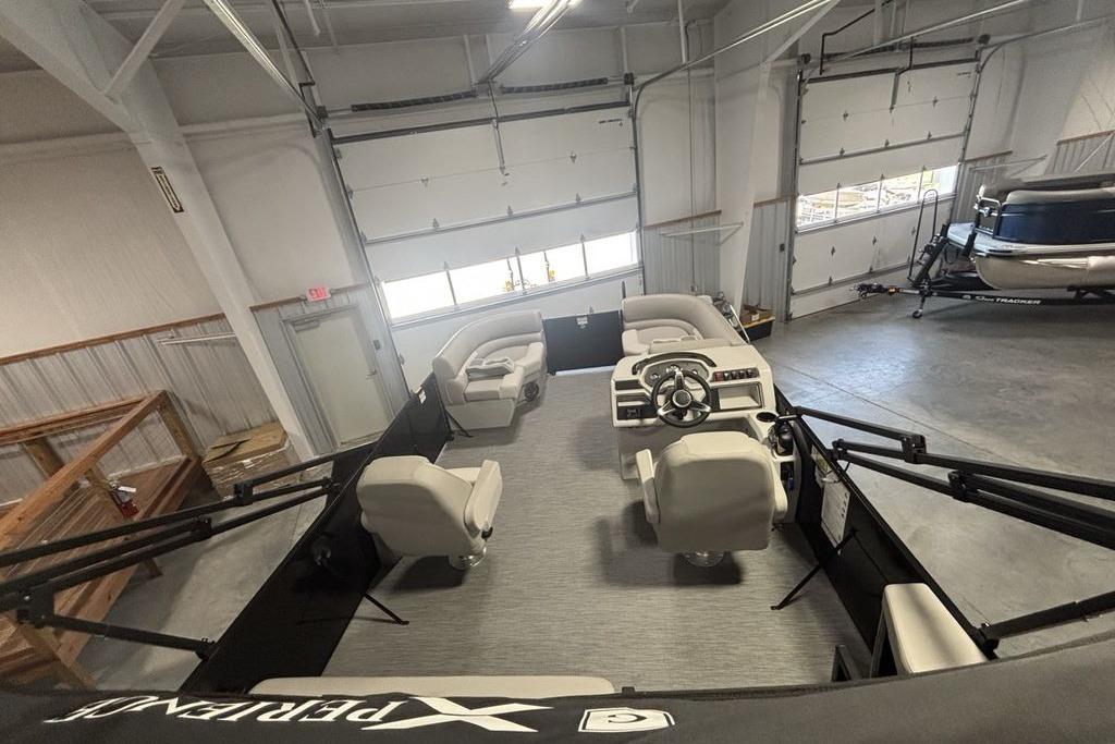 Interior view of 2026 Godfrey Xperience 2086 SFLX boat in a garage setting.