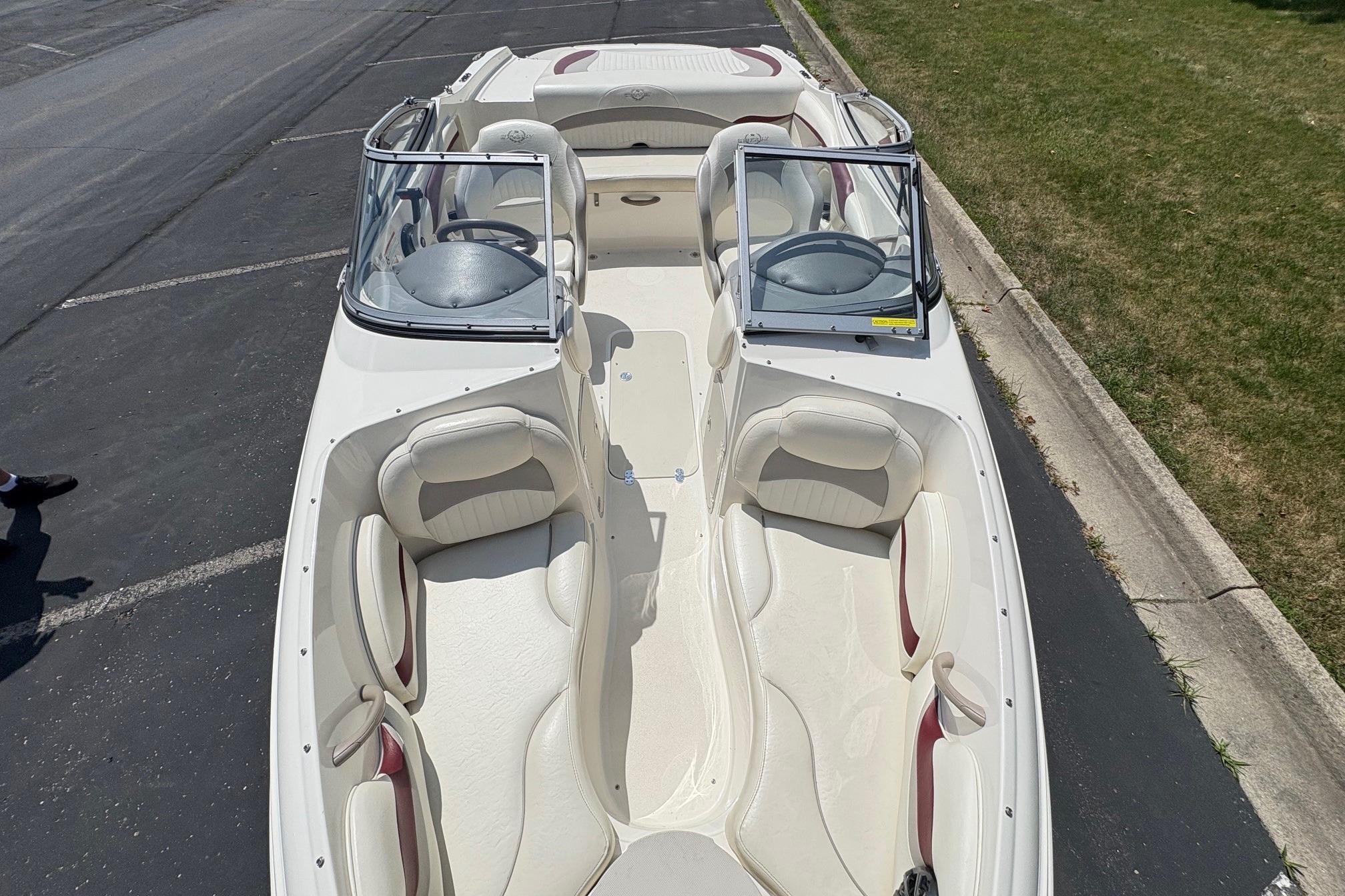 A 2013 Stingray 198 LX boat with white interior and dual consoles.
