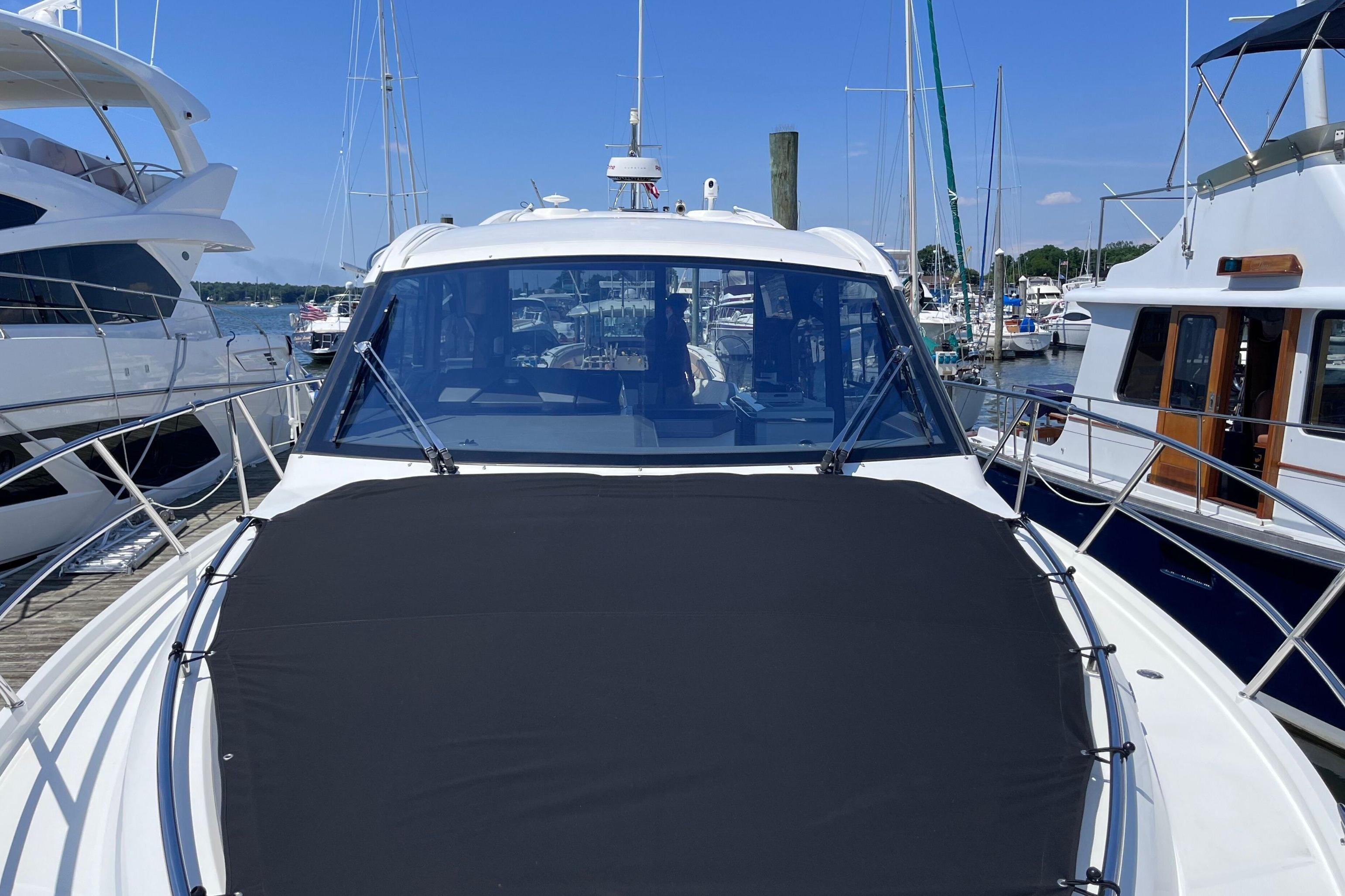 2024 Galeon 425 HTS yacht docked at marina under clear blue sky.