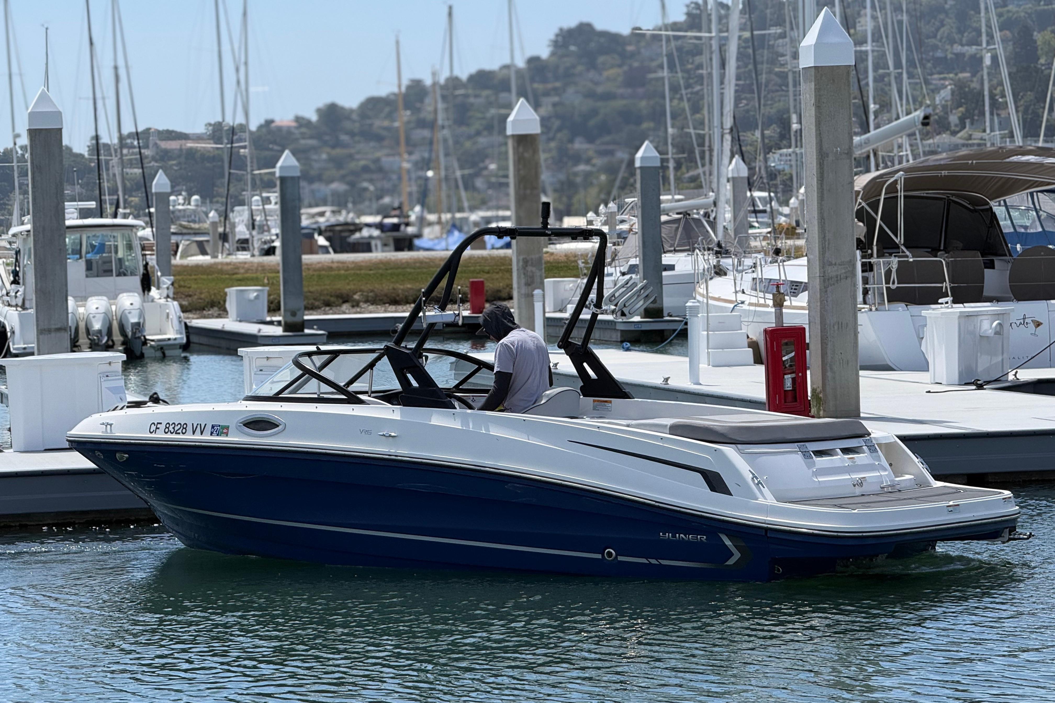 2021 Bayliner VR5 Bowrider I/O in marina, sleek design, blue and white exterior.