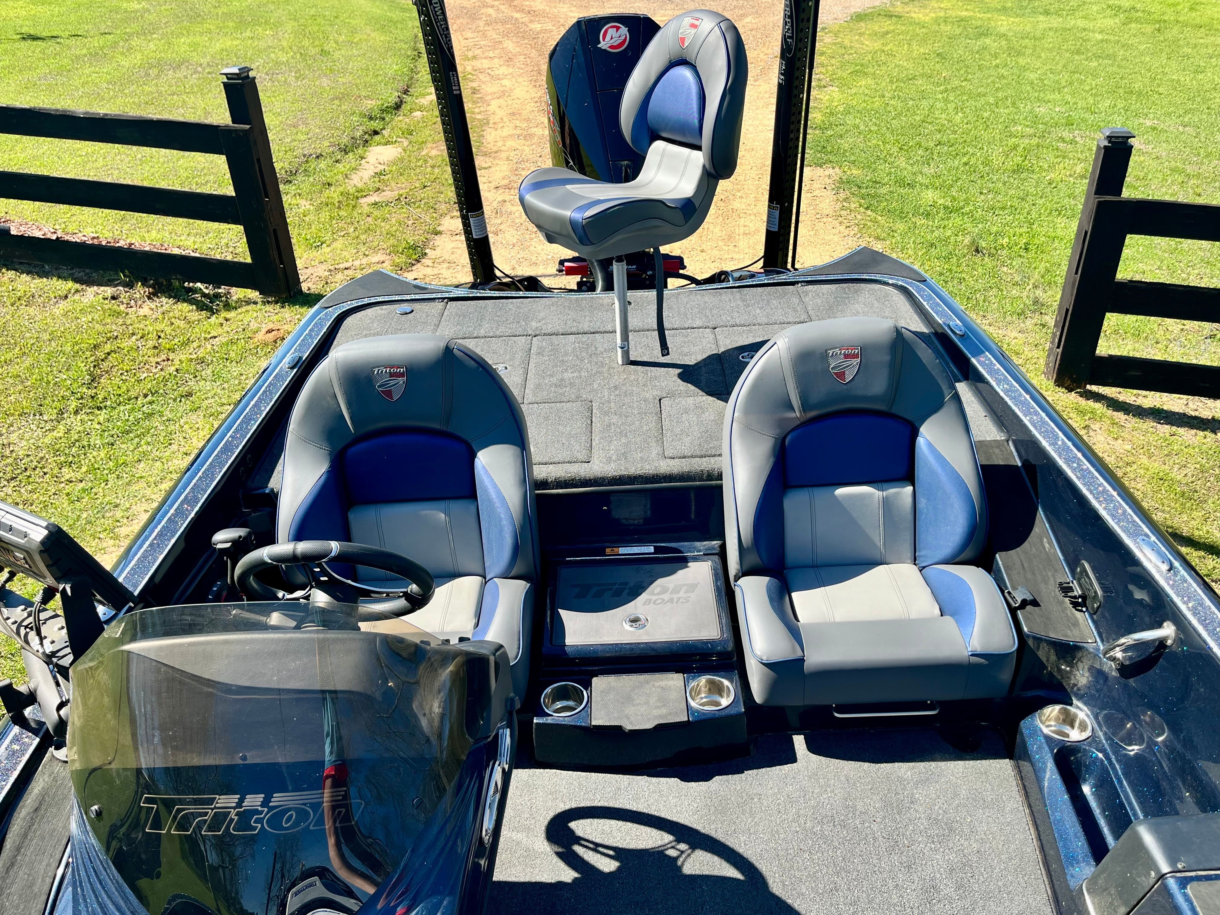 The image shows the cockpit of a 2023 Triton 20 TrX Patriot boat with two seats.