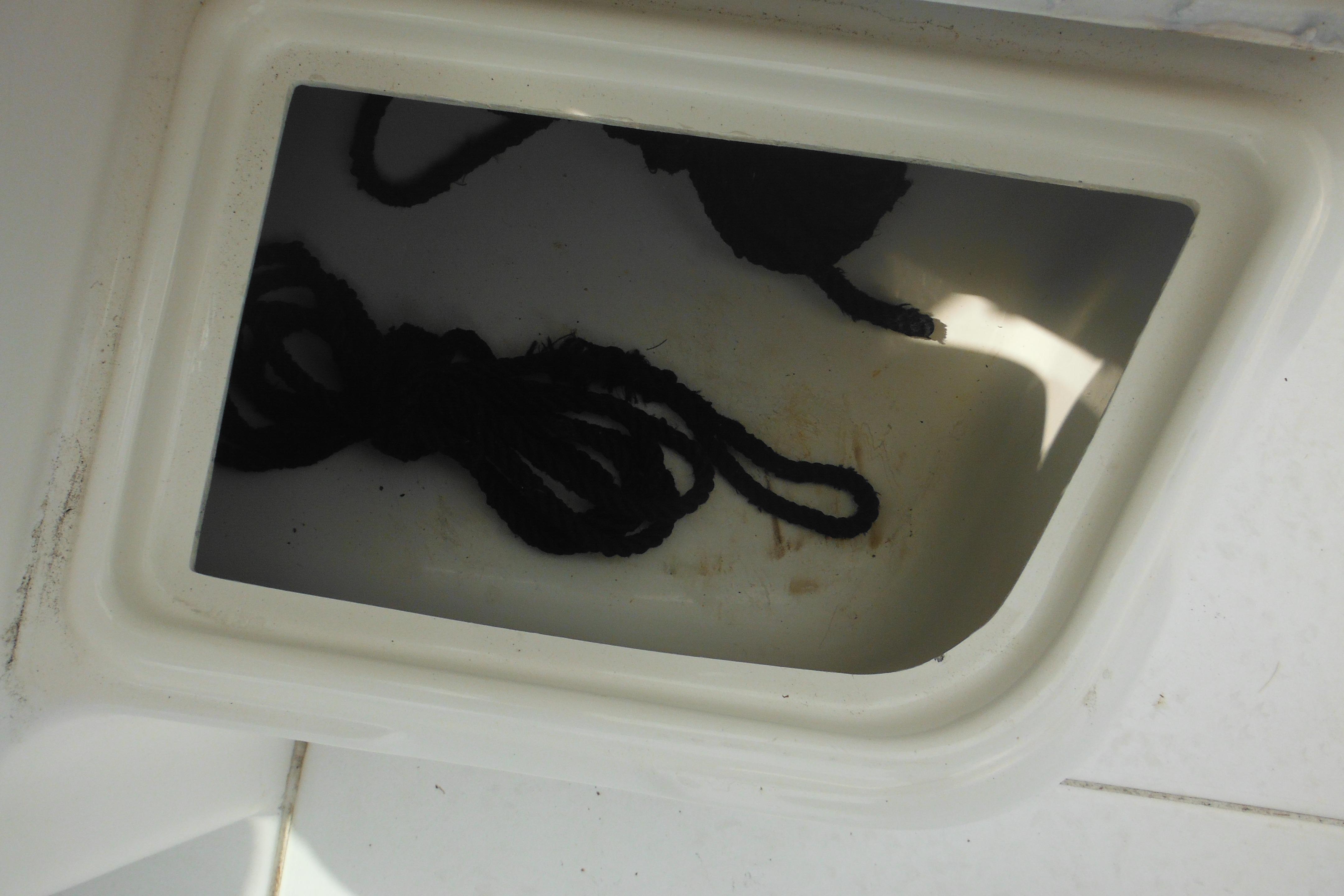 Storage compartment on 2005 Seaswirl Striper 2101 Walkaround O/B with coiled rope inside.