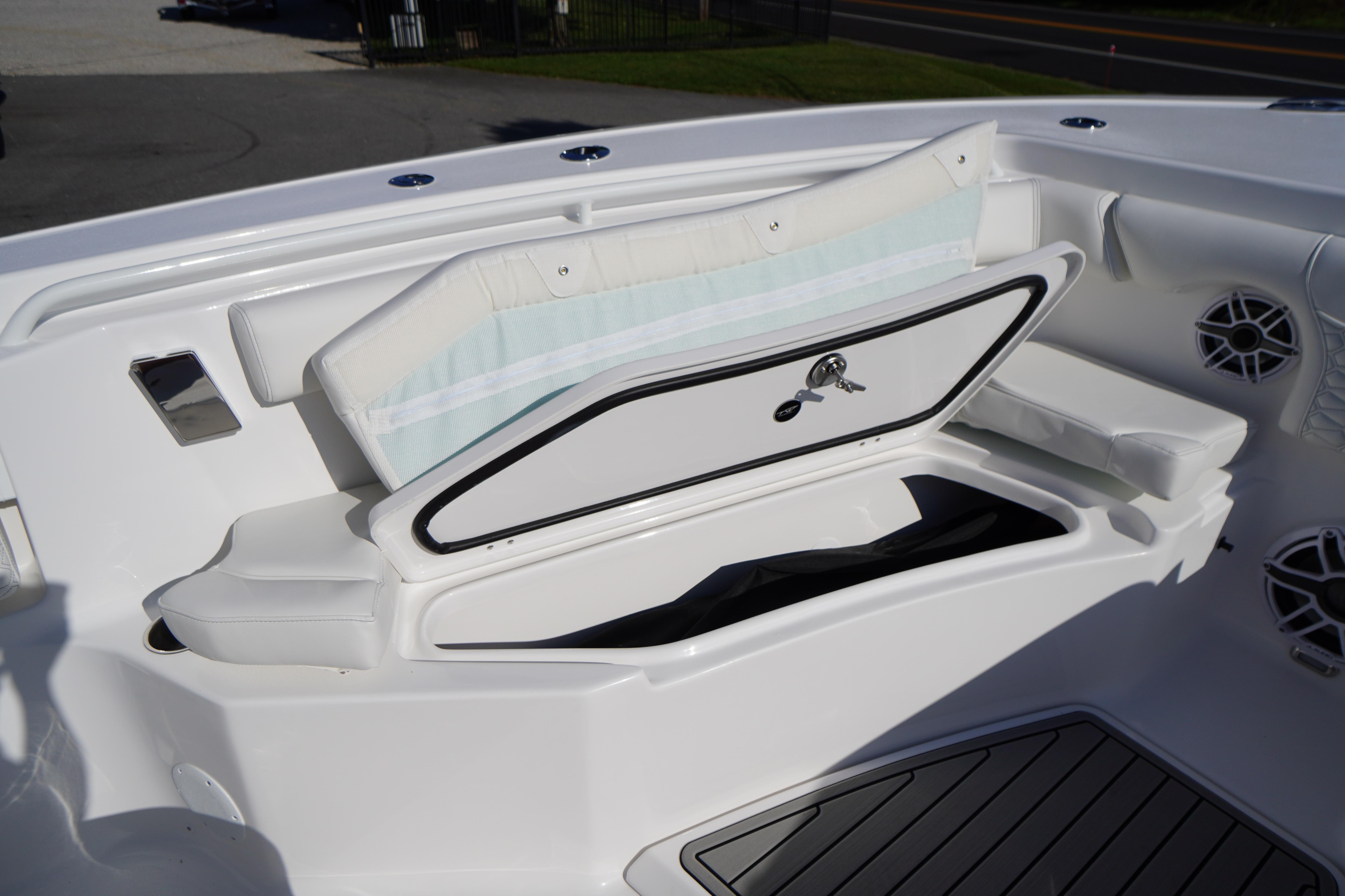 2026 Tidewater 272 LXF boat with open storage compartment and cushioned seating.