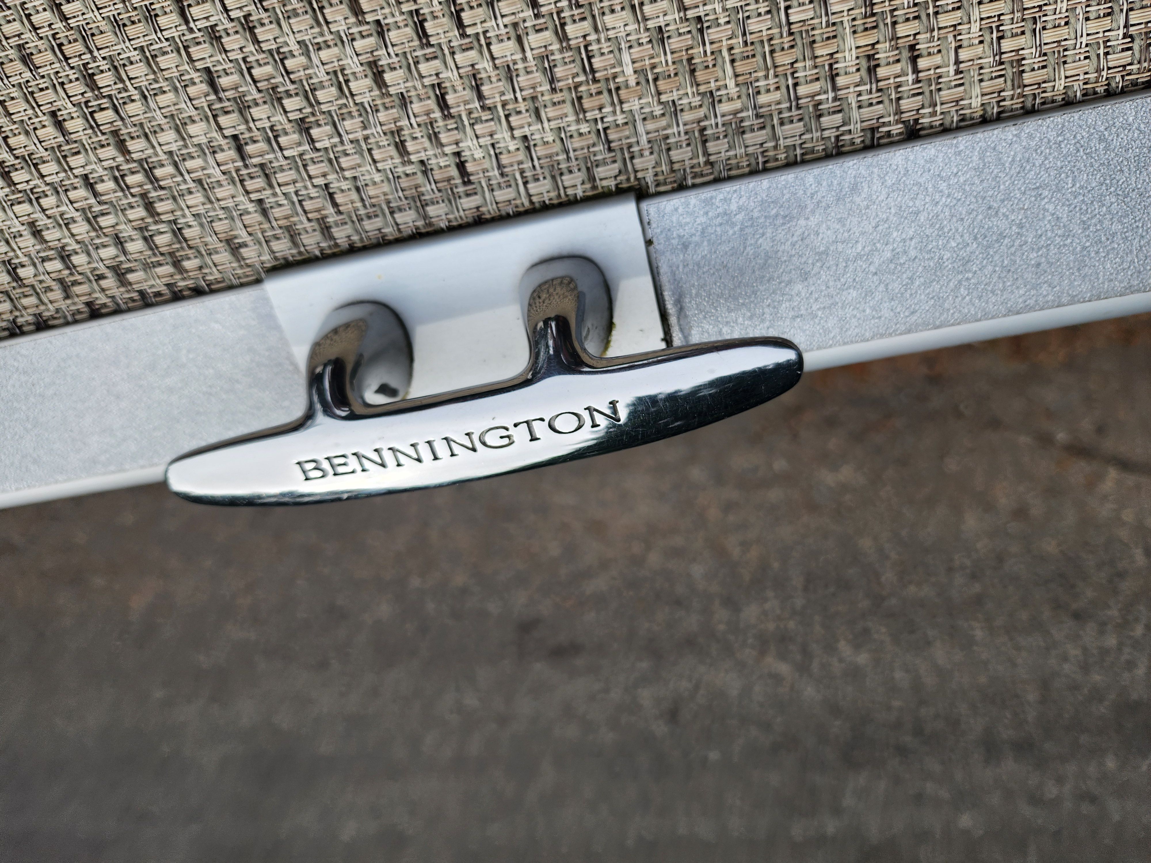 Close-up of a Bennington boat detail with a silver fitting on woven material.