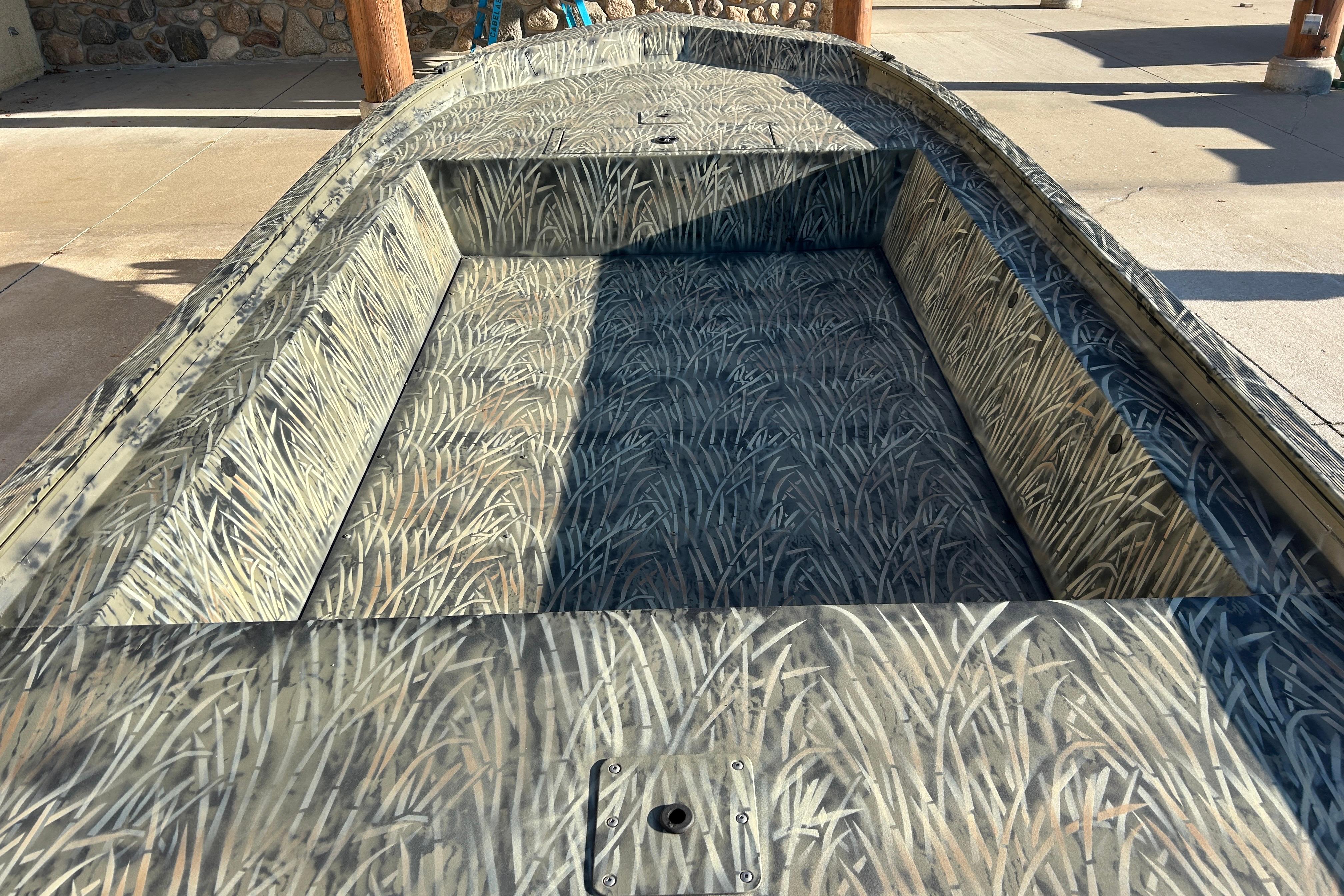 2026 Tracker Grizzly 1754 Utility boat with camouflage interior design.