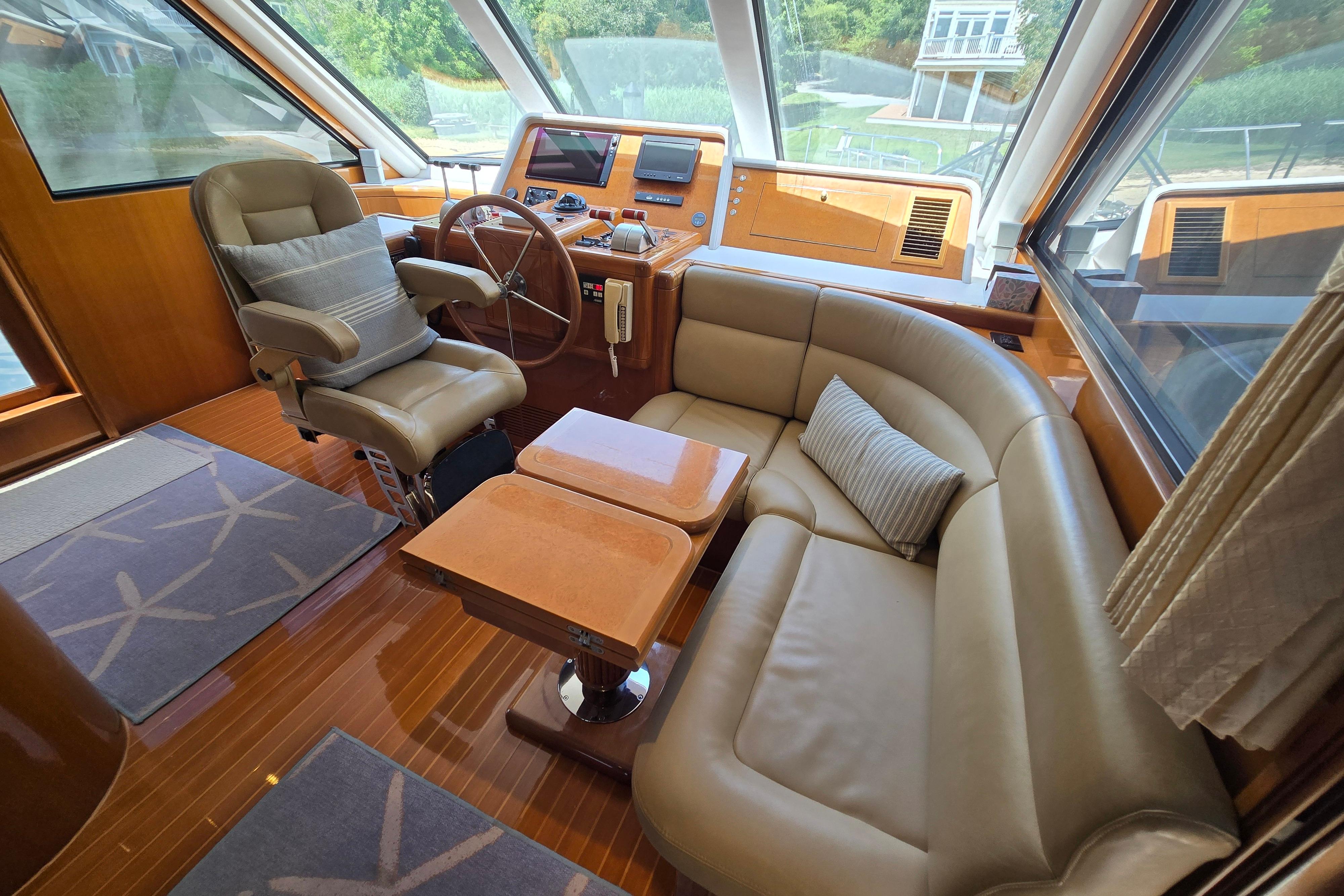 Luxurious 2004 Grand Harbour 58 yacht interior with leather seating and modern helm station.